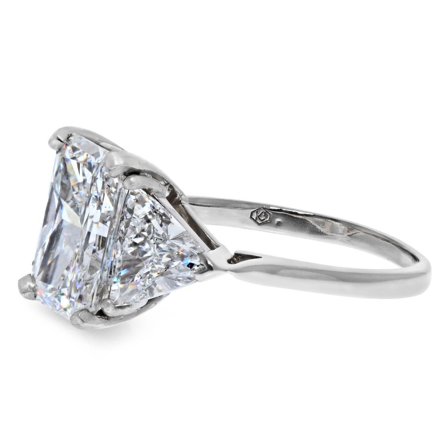 5.56 carat three stone radiant cut ring mounted with a GIA certified G color VS2 clarity natural diamond, flanked by (2) trilliant cut natural diamonds of 1.95cts in total weight. 
This is an engagement ring that offers a lot of brilliance, and big
