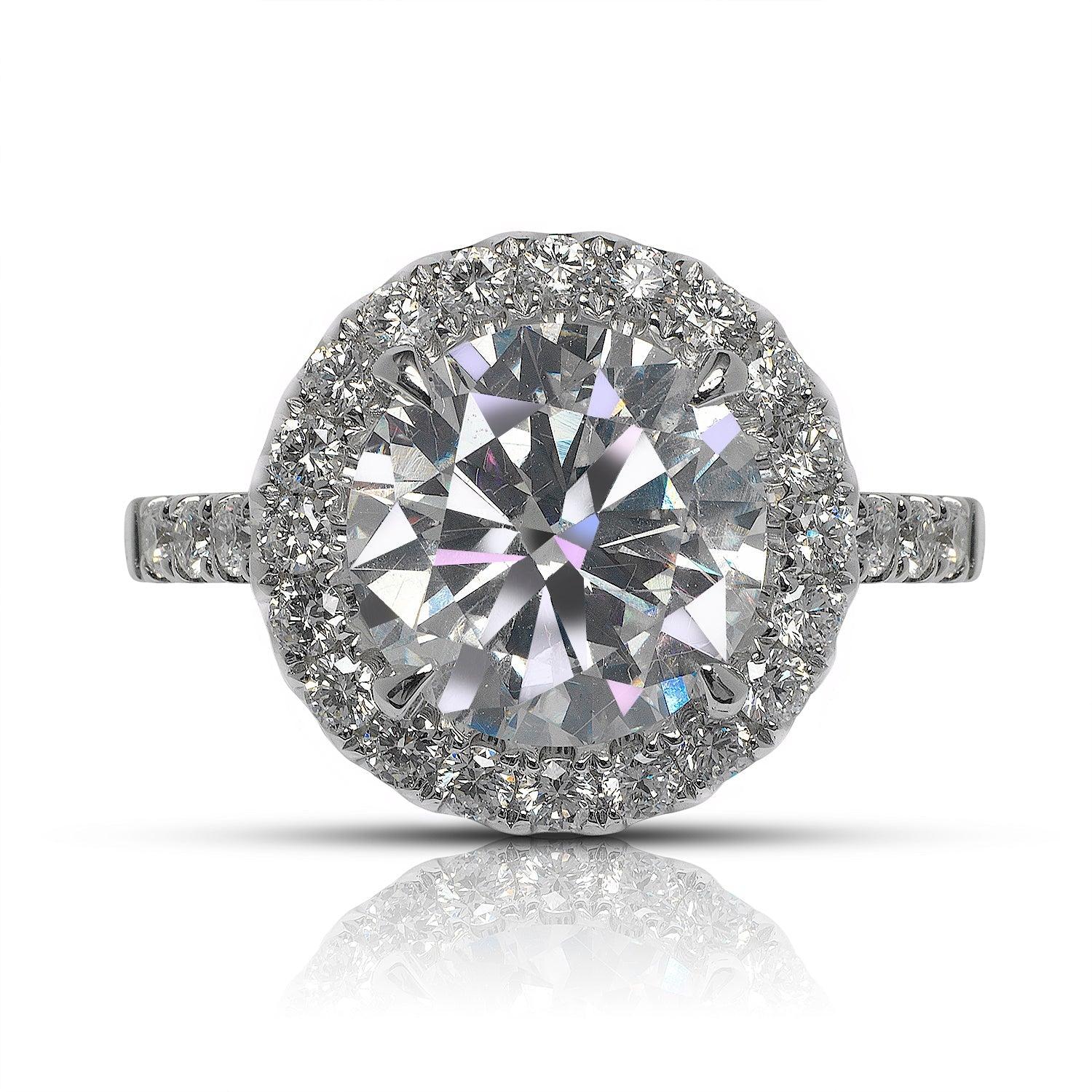 ZETA HALO DIAMOND ENGAGEMENT RING 18K WHITE GOLD 


CERTIFIED
Center Diamond
Carat Weight: 3.6 Carats
Color :   E
Clarity:  VS2*
Cut: ROUND BRILLIANT
Measurements: 9.8 x 9.8 x 5.8 mm
*Clarity Enhanced

Ring:
Metal: 18K WHITE GOLD
Style: HALO RING