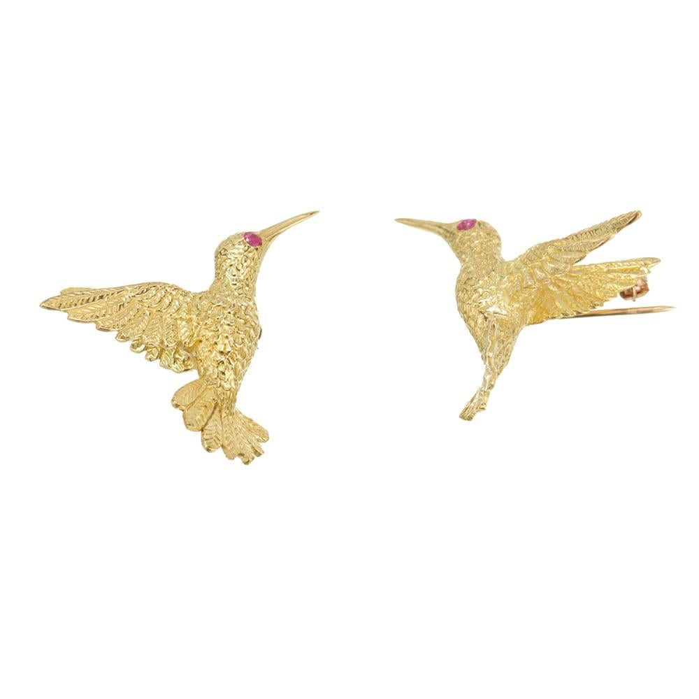 Left and right hand textured brooch set. Two 18k yellow gold hummingbirds both set with one round red ruby eye. Highly detailed Circa 1970's. 

2 round red rubies, approx. .5cts
18k yellow gold 
Stamped: 18k
12.5 grams
Top to bottom: 25.8mm or 1