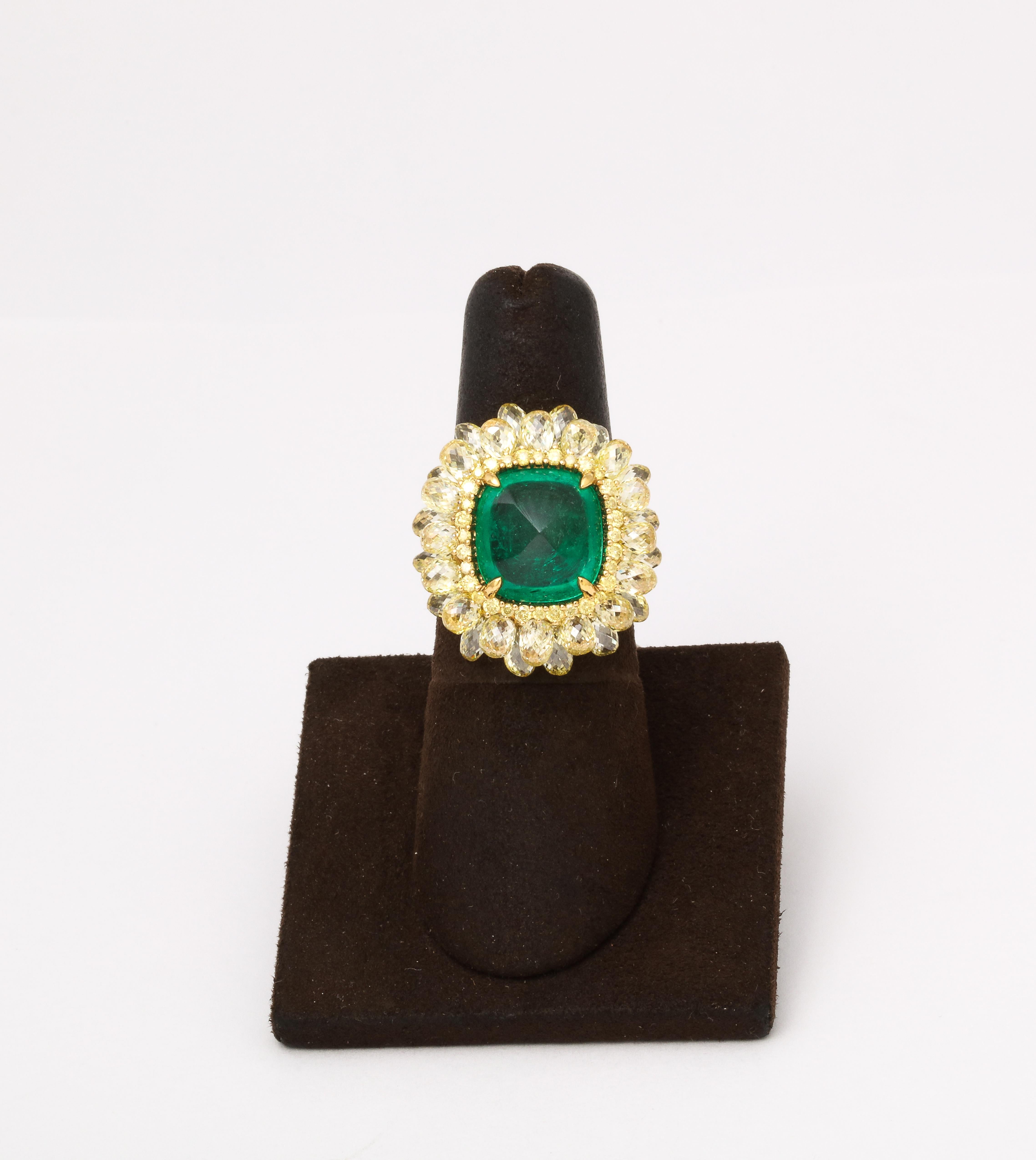 
A WORK OF ART! 

Impeccably designed 5.59 carat Colombian Sugarloaf Cabochon Emerald ring. 

The ring is set with 10.85 carats of yellow Briolette and Round Brilliant cut diamonds all set in 18k yellow gold. 

Approximately .85 inches in length and