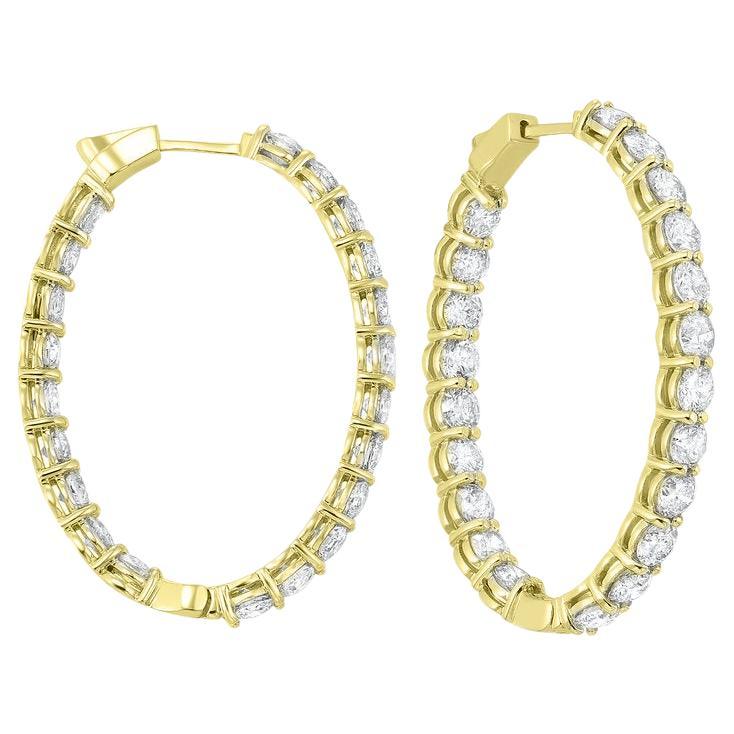 Nothing says luxury like an incredible pair of diamond hoop earrings. These stunning brightly polished 14 karat yellow gold inside out oval-shaped hoop earrings feature a total of 52 round brilliant cut diamonds totaling 5.00 carats are prong set on