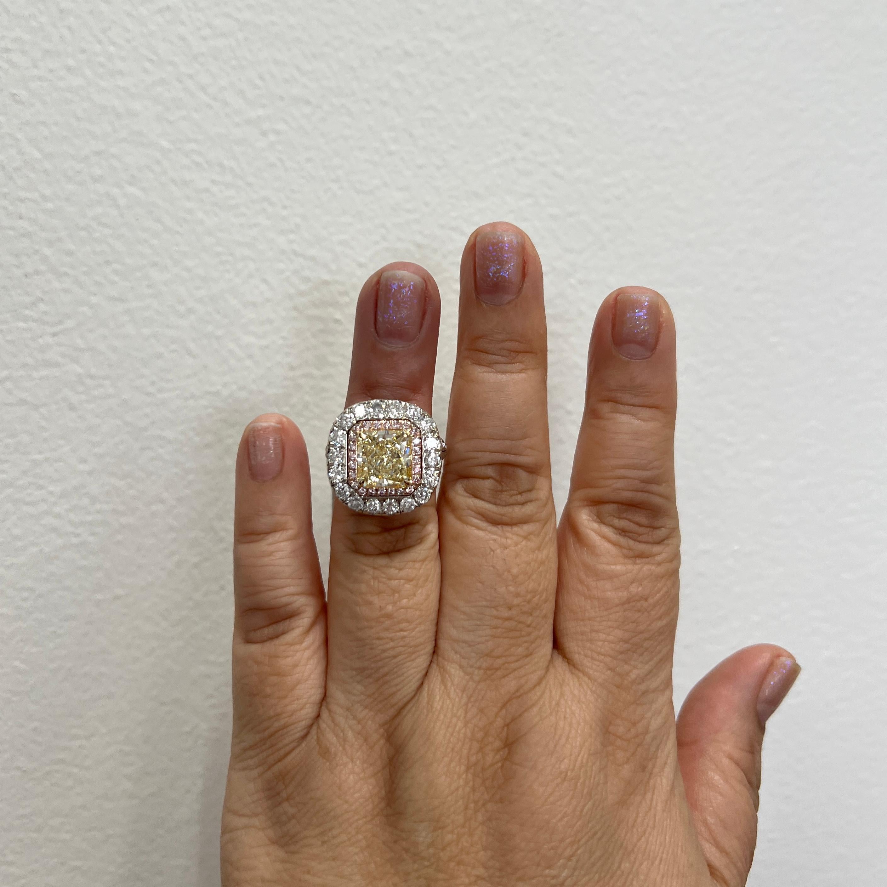 Beautiful 5.09 ct. natural yellow diamond radiant with natural pink and white diamond rounds.  Handmade in 18k white and yellow gold.  Ring size 5.5.