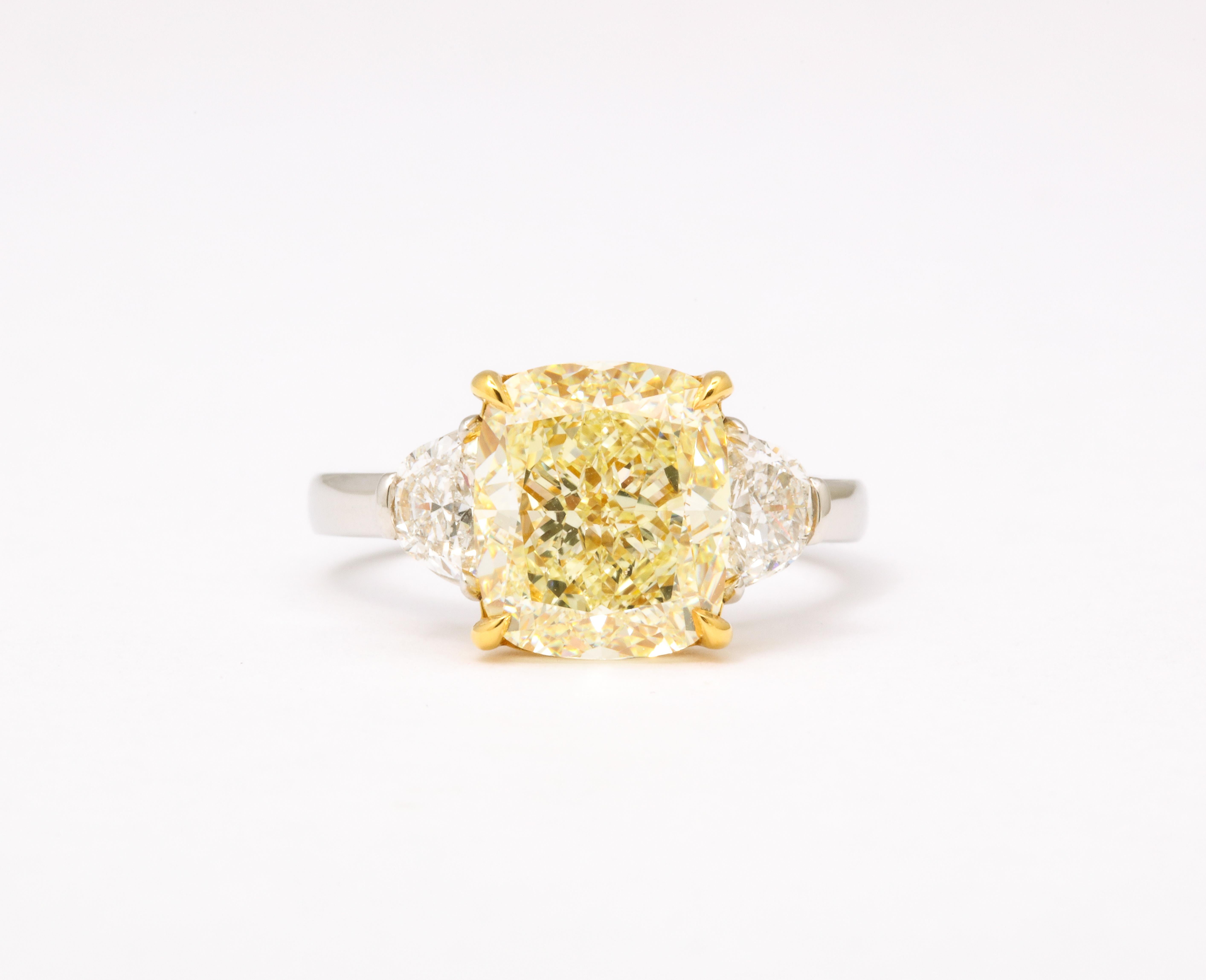 
GIA certified 5 carat Fancy Light Yellow, VS1 clarity Cushion cut center diamond. 

.70 carats of white side diamonds. 

Set in a custom platinum and 18k yellow gold mounting. 

Size 6.25, this ring can easily be sized. 