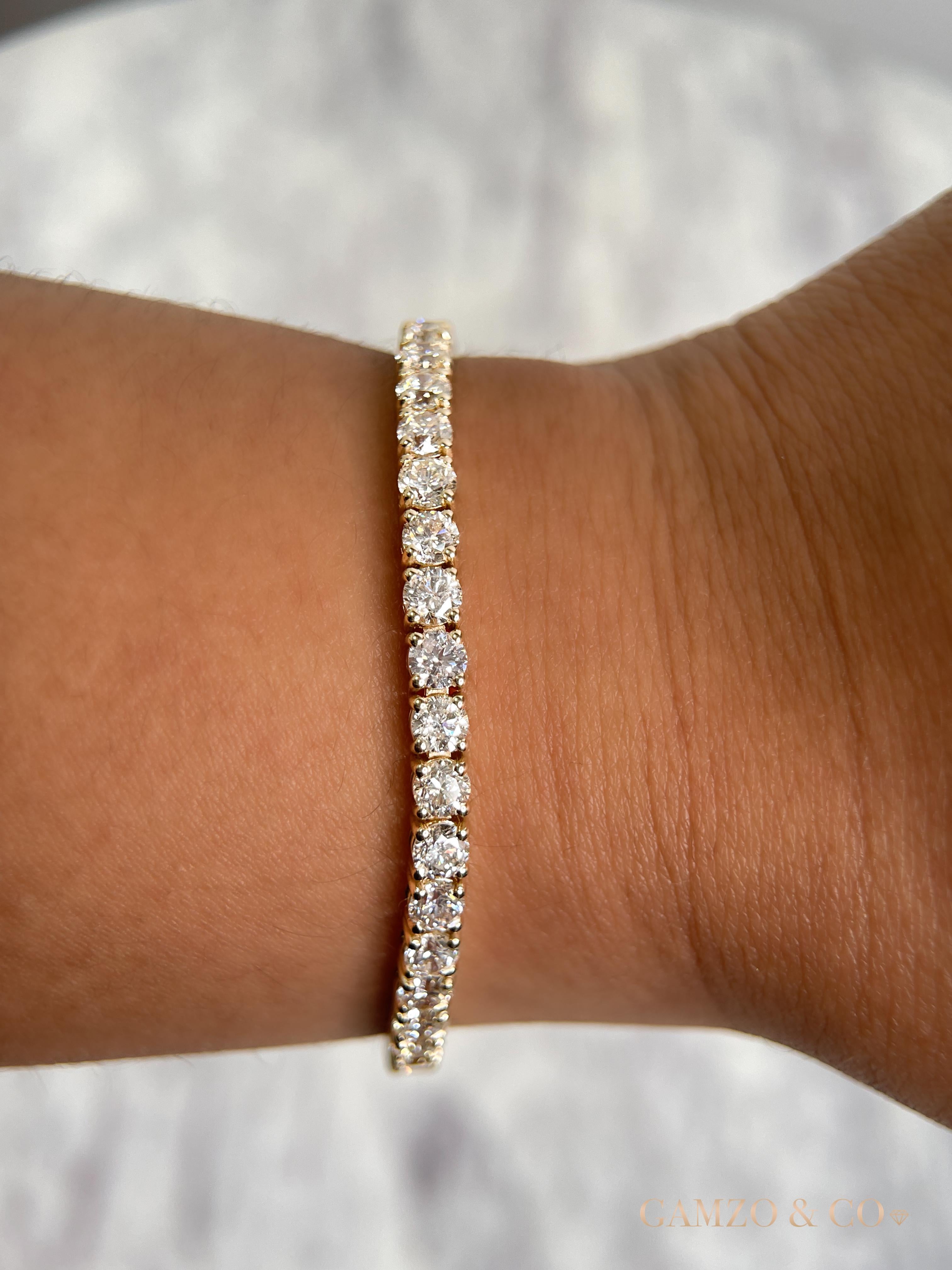 This diamond tennis bracelet features beautifully cut round diamonds set gorgeously in 14k gold.

Metal: 14k Gold
Diamond Cut: Round Natural Diamond 
Total Diamond Carats: 5ct
Diamond Clarity: VS-SI
Diamond Color: F-G
Color: Yellow Gold
Bracelet