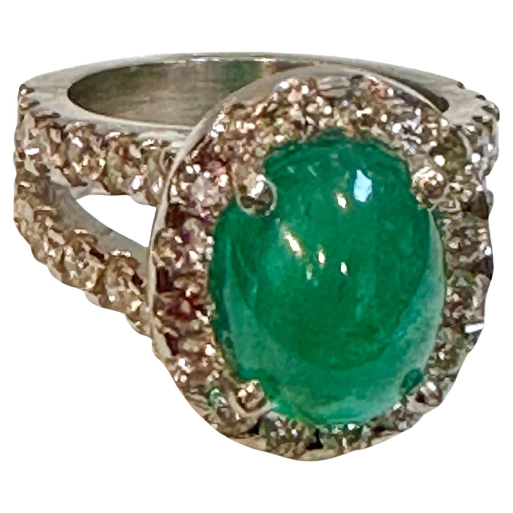 A classic, Cocktail ring 
5 Carat Zambian Emerald Cabochon & Diamond Cocktail  Ring 18 Karat White Gold with diamond  on the band  , Estate with no color enhancement. 
Gold: 18 Karat  White  gold ,
Weight: 16  gram with stone 
Diamond approximately