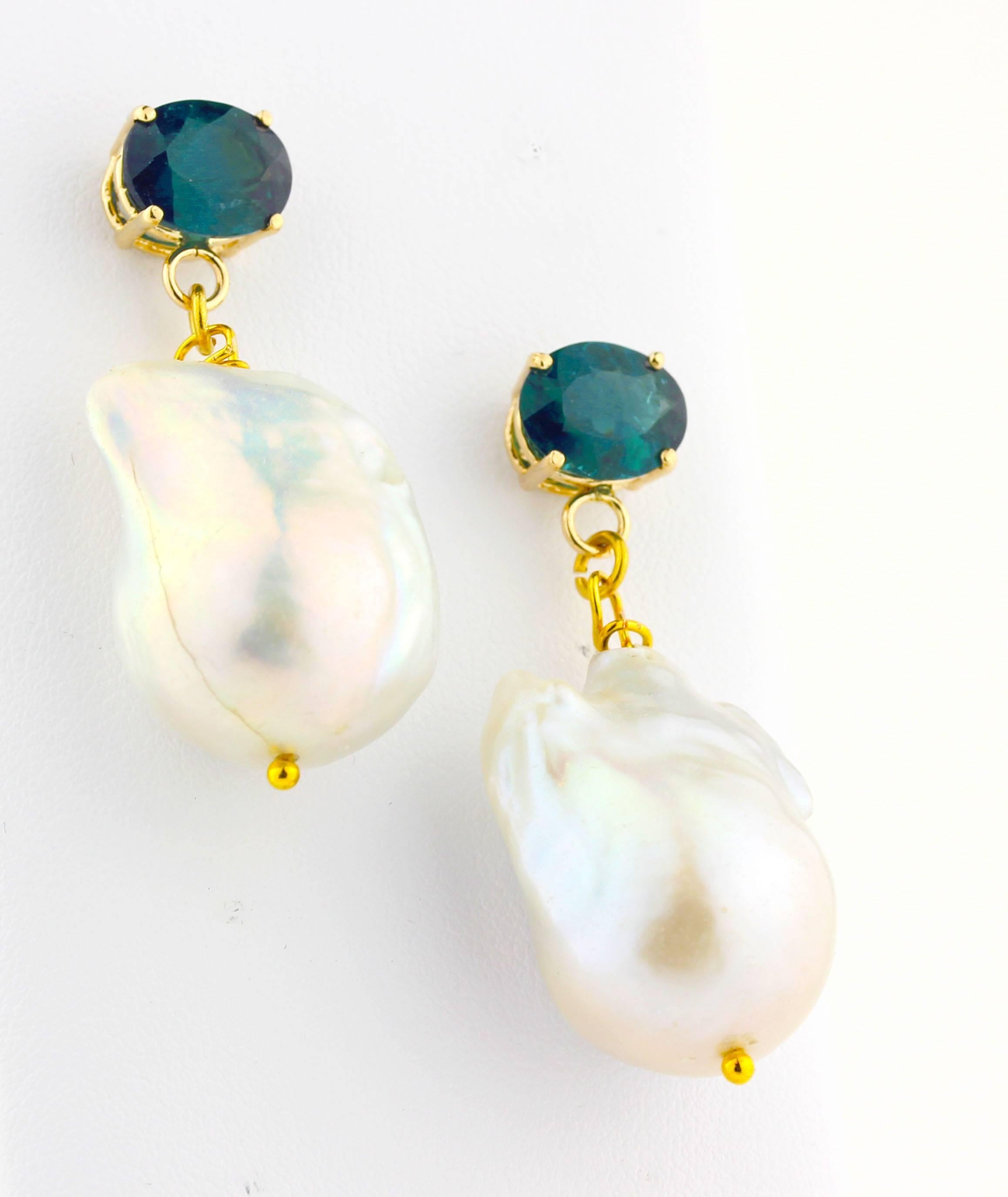 These 5 carats of unique glittery bluishgreenish natural Indicolites (tourmalines) (10 mm x 8 mm) elegantly dangle large cultured Baroque Pearls set in handmade 14K yellow gold stud earrings.  Their color enhances from bluish to greenish depending