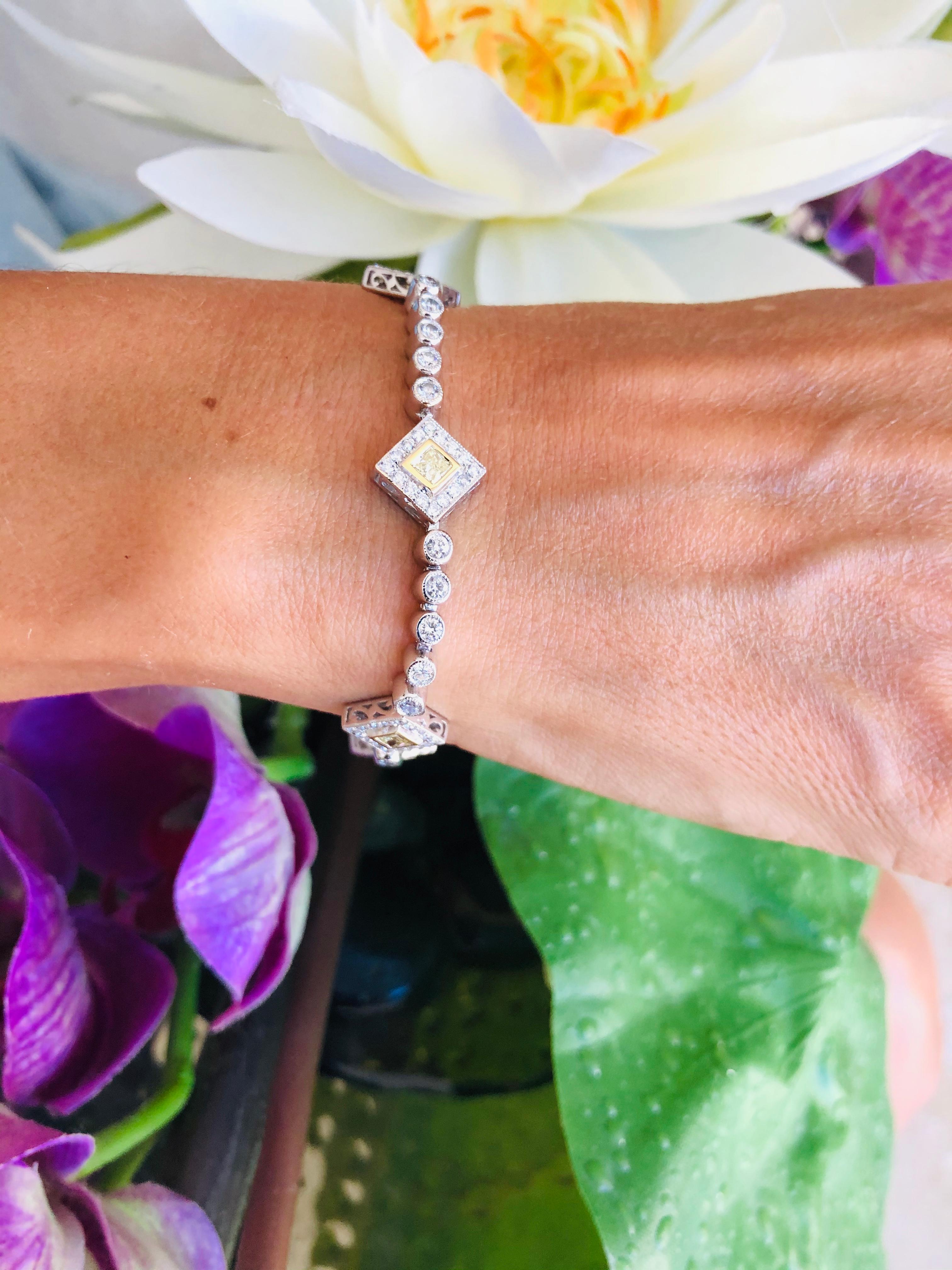 Offered here is a gorgeous two tone diamond bracelet set in 18kt gold. The bracelet has 126 round brilliant cut diamonds G-H color Vs2 in clarity with an estimated total weight of 3 carats and 6 natural yellow diamonds Vs2 clarity with approximately