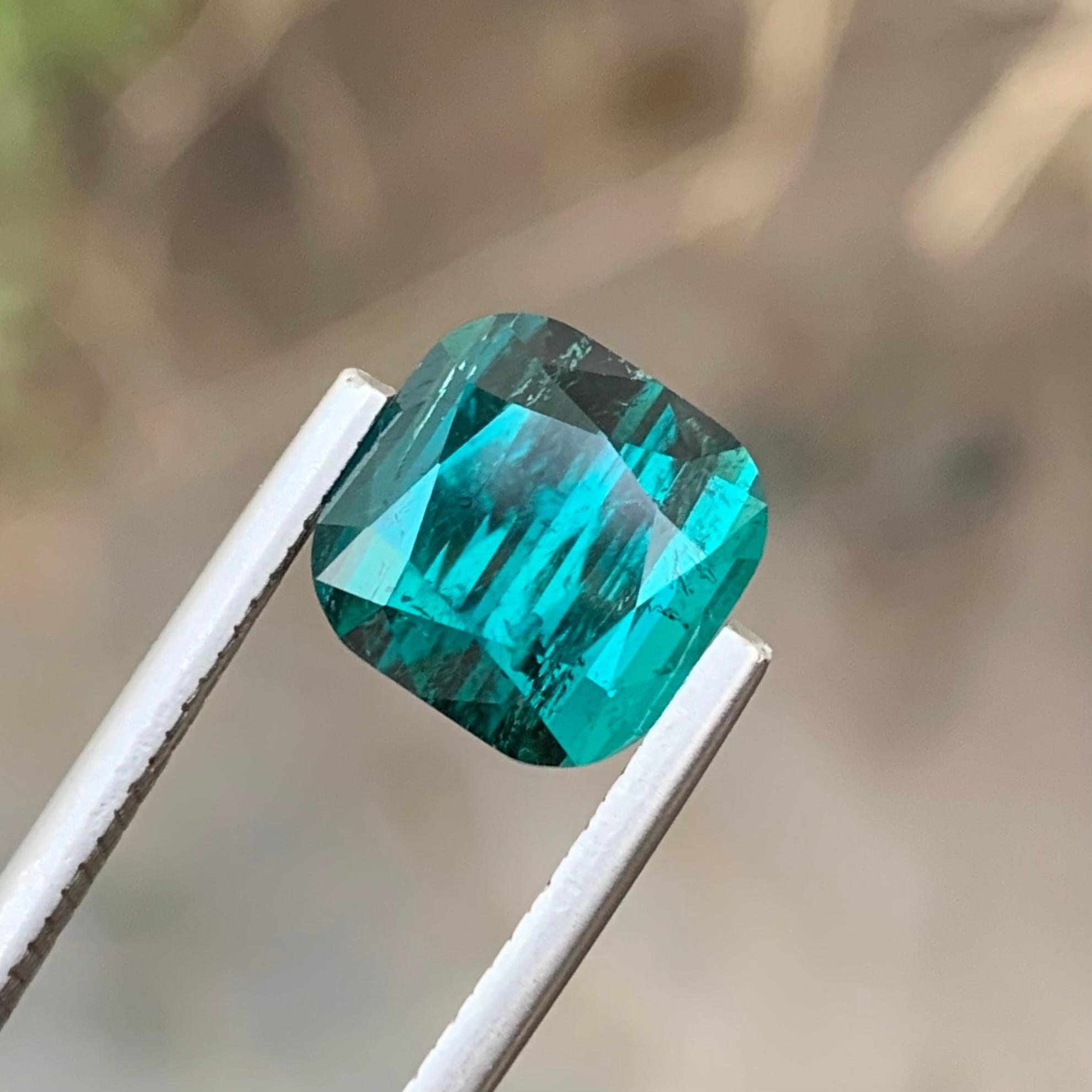 Loose Tourmaline 
Weight: 5 Carats 
Dimension: 9.1x9.1x7 Mm
Origin: Kunar Afghanistan 
Shape: Cushion
Color: Lagoon
Treatment: Non
Clarity: Small Included
Lagoon Tourmaline is a mesmerizing gemstone renowned for its captivating color spectrum.