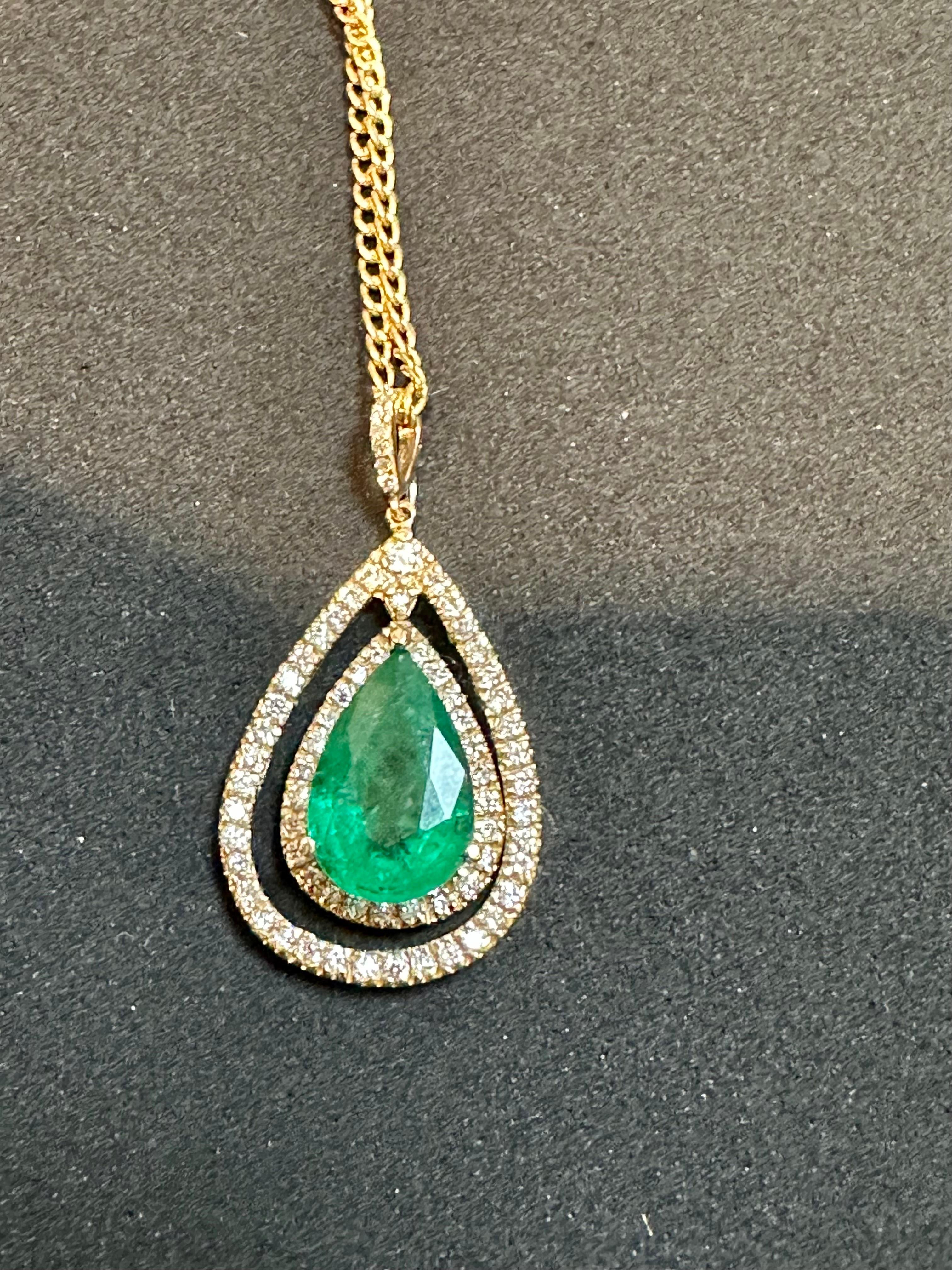 Approximately 5 Ct Natural Emerald Zambia & Diamond Pendant 14 Karat Yellow Gold Chain
 Emerald is about 5 carat 
There are approximately 1.2 ct of diamonds
The center pear shape stone is surrounded by two rows of diamonds.
Very desirable color and