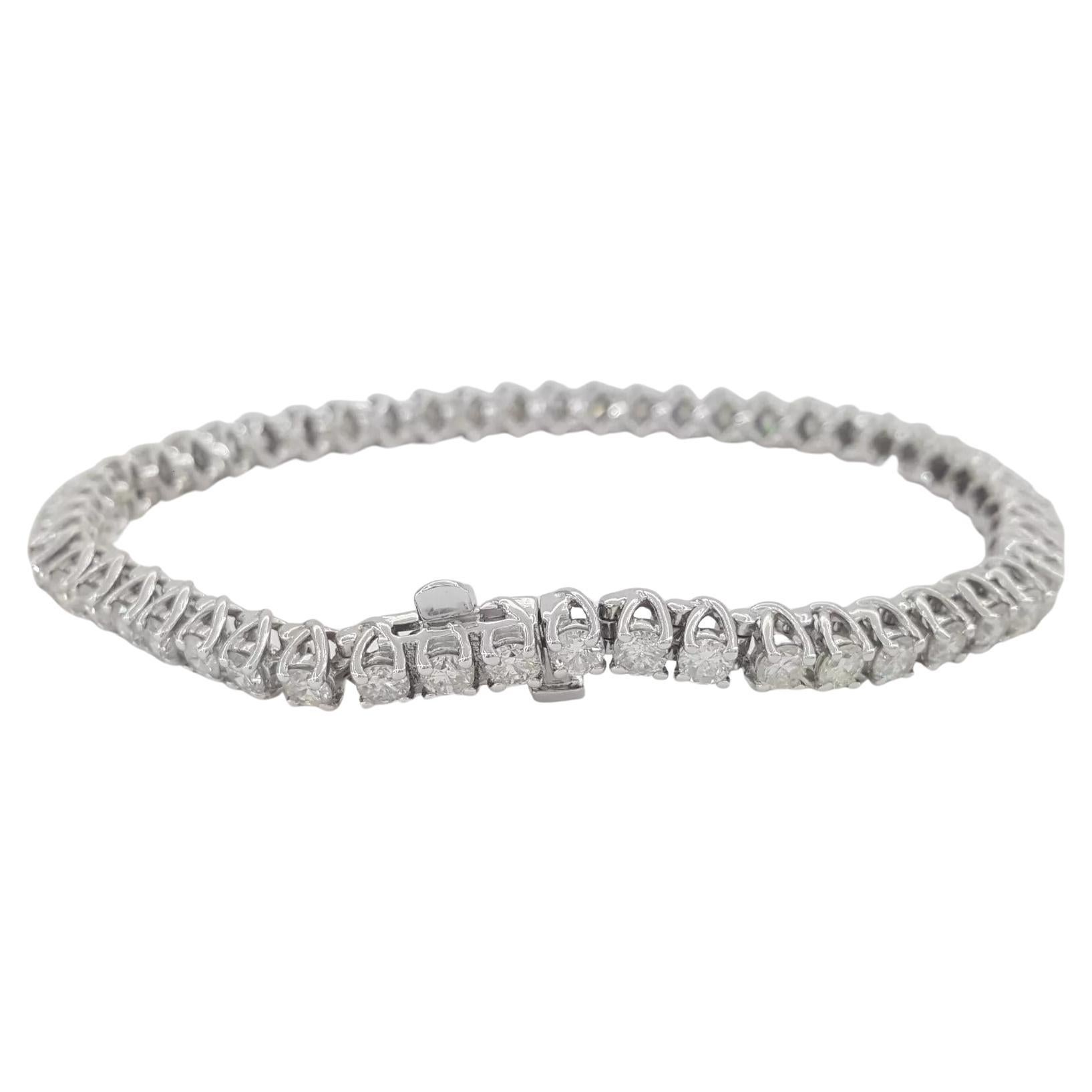 5 ct total weight Round Brilliant Cut Diamond Straight Line Tennis Bracelet in 14K White Gold. 

The bracelet weighs 15 grams, 7 inches in length, there are 52 Natural Round Brilliant Cut diamonds weighing approximately 5ct total weight, G-I in