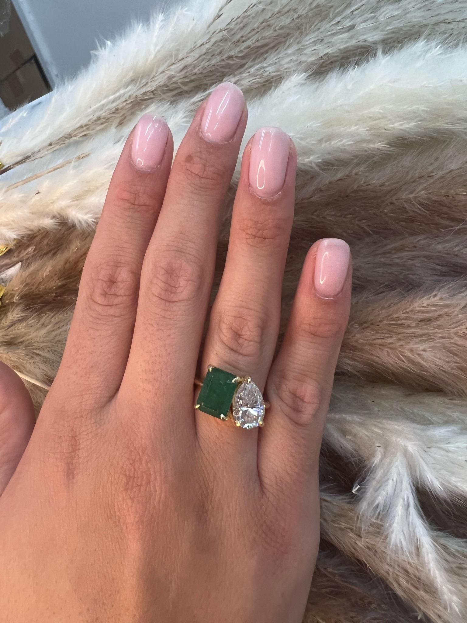 This ring is a stunning Toi Et Moi Engagement Ring that features a Green Emerald Cut Emerald and a brilliant Pear Shape Diamonds that will surely catch anyone's attention. Set in a sleek and durable 14K Yellow Gold Band. Looking for the perfect gift