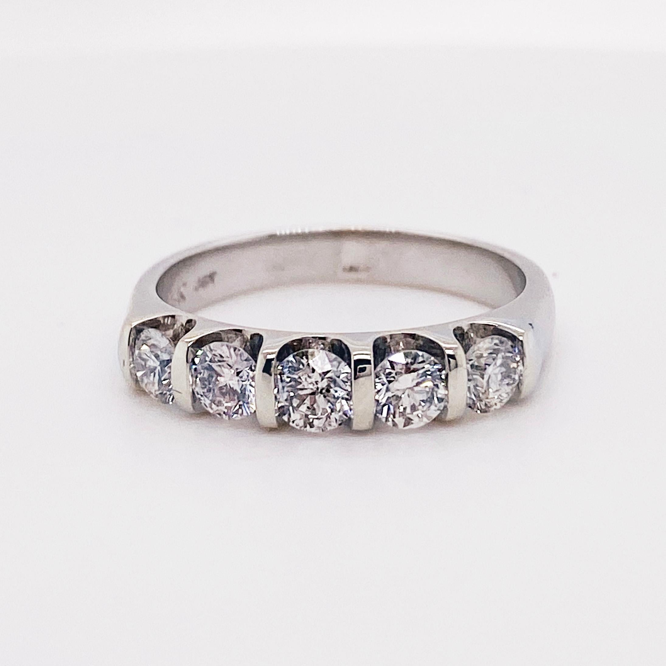 The five diamond band is a classic anniversary band have round brilliant diamonds. The round brilliant diamonds have a total weight of .75 carats and are set in vertical channel setting that are modern and clean! The ring is made with 14 karat white