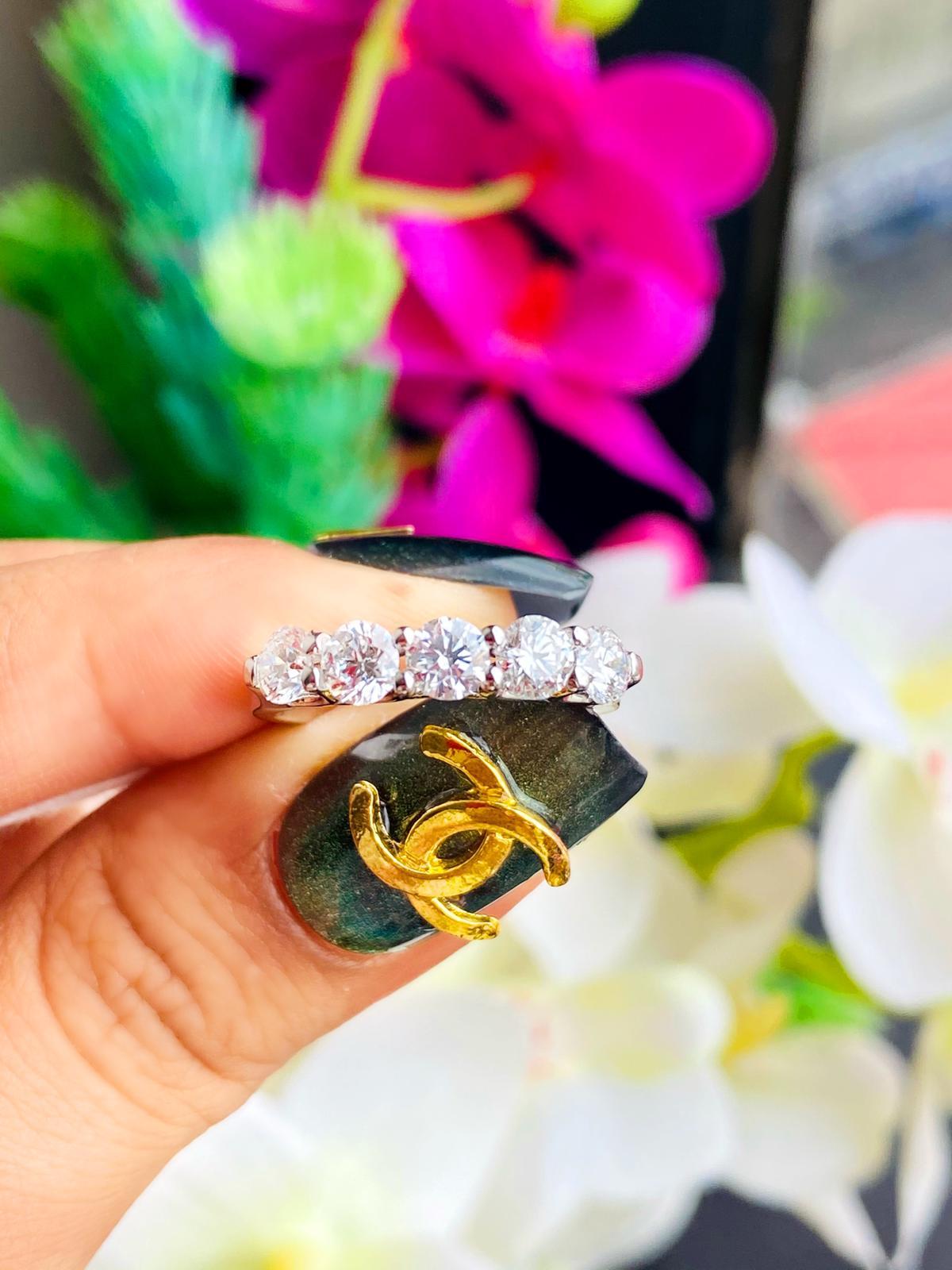 18kt white gold ring with diamonds
  
  Gold colour & Carat: White gold 18kt
  Weight: 4.07 grams
 
  Set with-
  Stone type: Diamonds
  Shape: Round
  Carat: 0.98 ct (5 pcs)
  Colour: F
  Clarity: VS
  
  Stone type: Diamonds
  Shape: Round
 