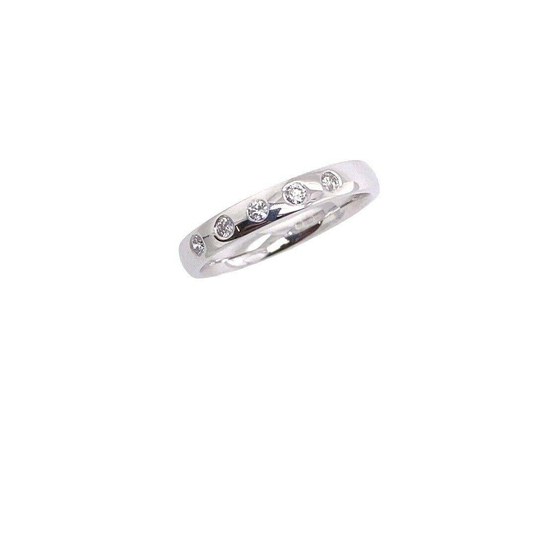 18ct White Gold 5-Diamond Rubover Set Wedding Ring Band, Set With 0.125ct
This wedding band features five diamonds in the rub over setting. The ring is made of 18ct white gold.

Additional Information:
Total Diamond Weight: 0.125ct
Diamond Colour: