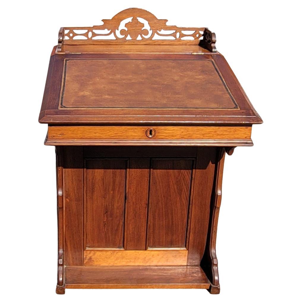 An exceptional 5-Drawer Mahogany Davenport desk with tooled leather top and gallery. 
The Davenport desk, sometimes originally known as a Devonport desk is a small desk with an inclined lifting desktop attached with hinges to the back of the body.