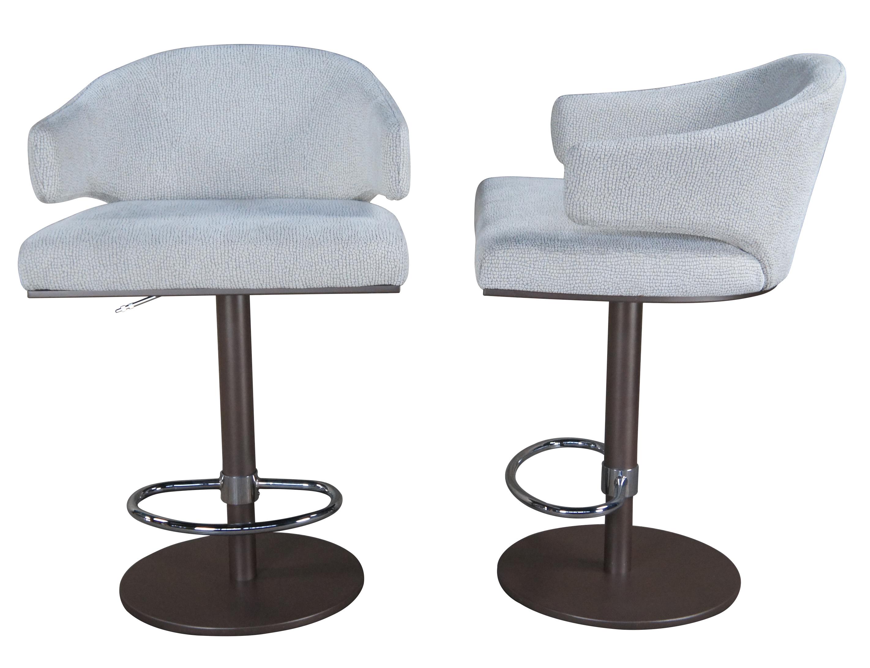A set of five vintage Elliot bar stools by Elite Mfg corp.

A nod to the classic Scandinavian modern era. The Elliot seating group is a unique mix of ergonomic comfort and sculptural form. This shell like back/arm has an unexpected under-arm cut