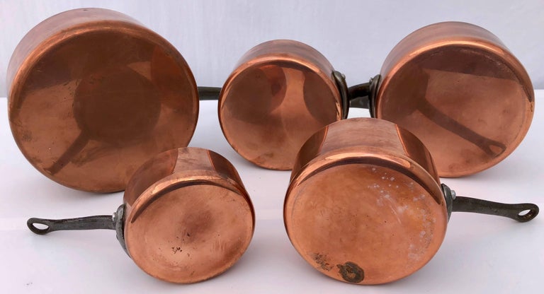 This French handmade set of five graduating copper pans have wrought iron handles and are a professional grade. The tin plated interiors are like new. They were probably made in  Villedieu-les-Poêles in Normandy.

Measure: large D 7.25, H