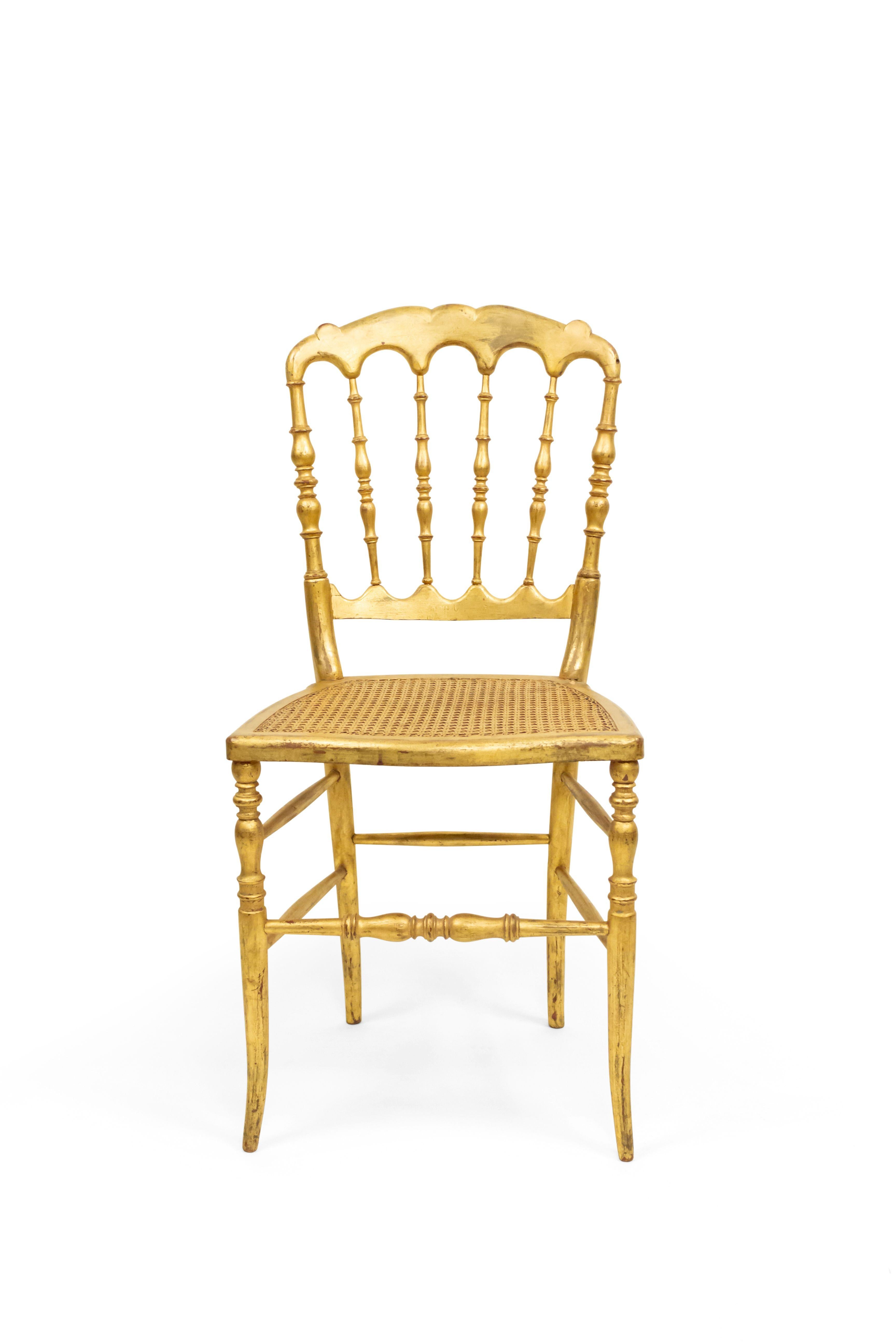 5 French Victorian style gilt ballroom side chairs with scalloped back and cane seat (PRICED EACH) (20th Cent.)

Condition: Good; Wear consistent with age and use