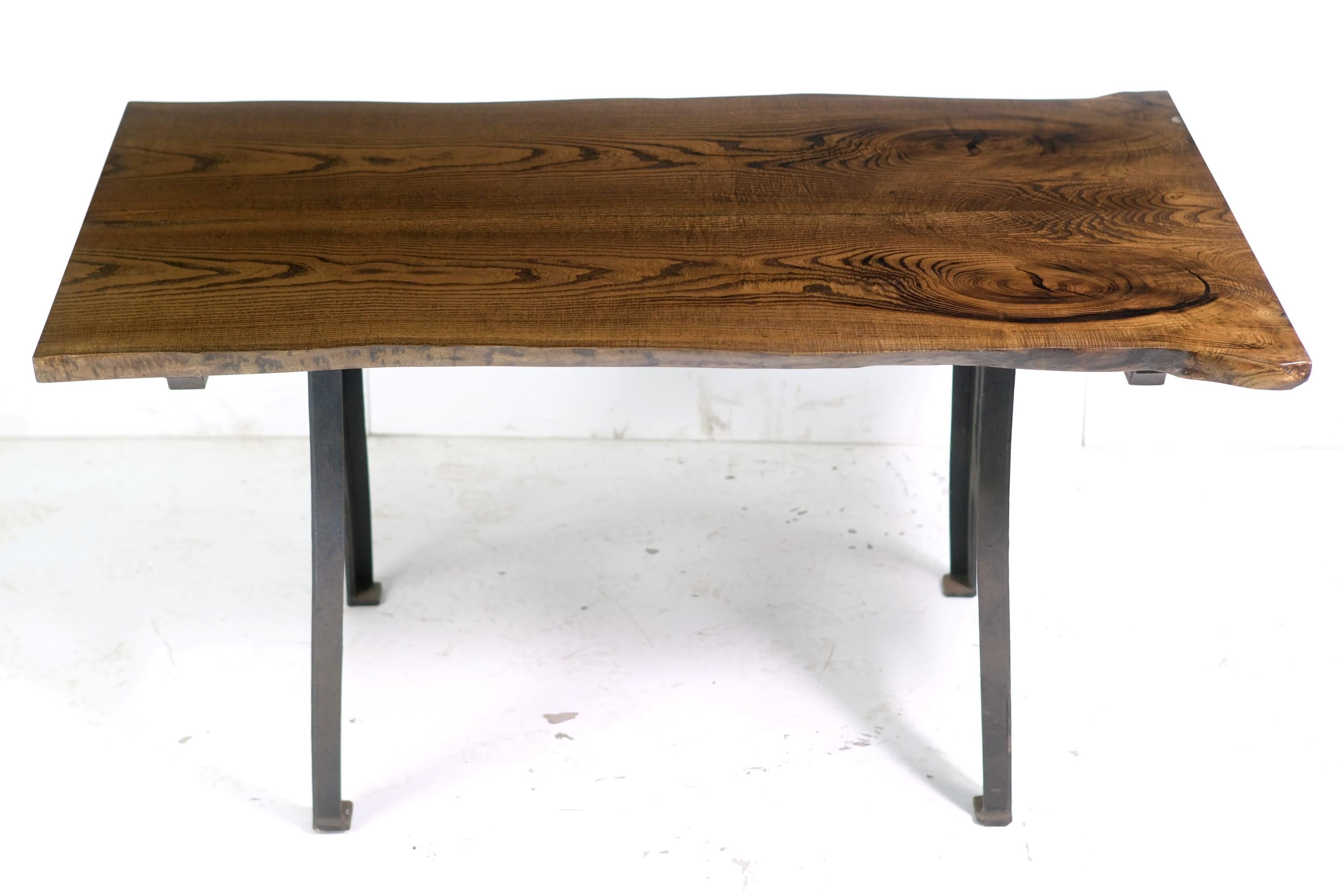 This live edge table features a two slab solid chestnut top with a dark walnut stain and a satin conversion varnish finish paired with cast iron New York legs. This table is ready to ship. Please note, this item is located in our Los Angeles