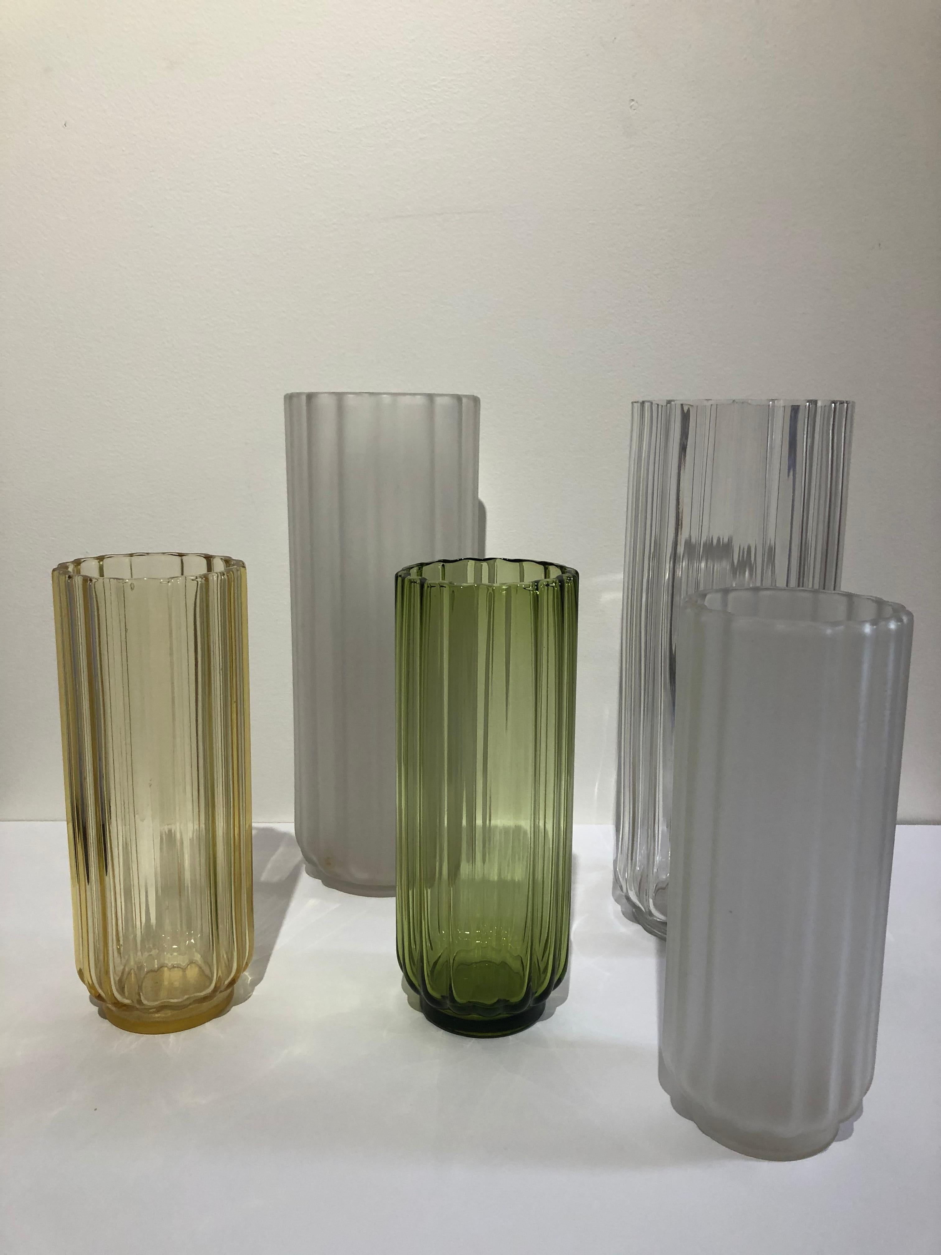 Set of 5 George Sakier glass vases, 1930s Fostoria Glass co, hard to find tall vases in very good condition. Large vases are 12.75 x 5” and smaller ones are 3.50 x 9.50 .George Sakier (1897–1988) was an American artist and industrial designer.[1][2]