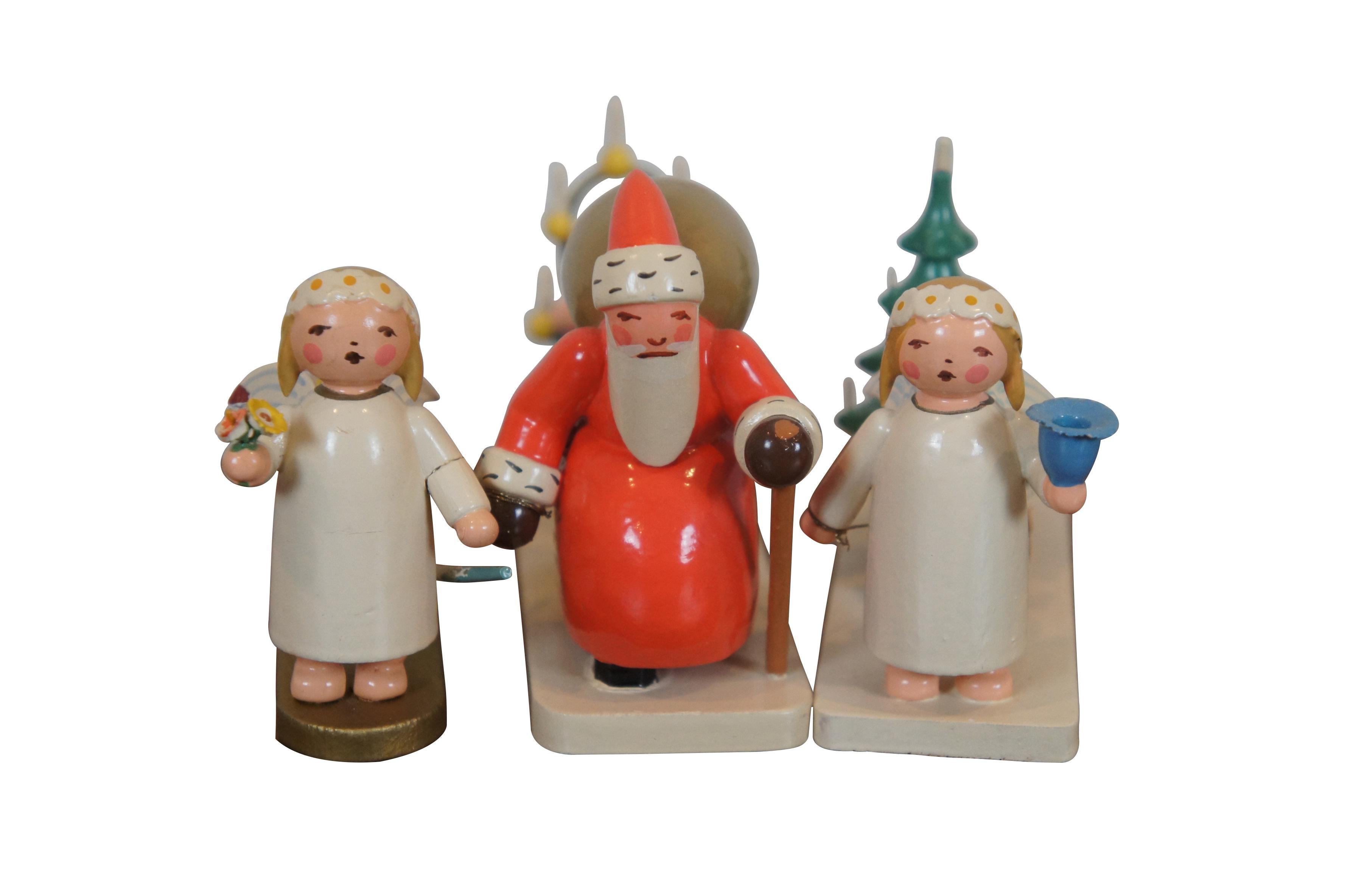 Set of 5 hand crafted wooden Christmas figurines by Wendt and Kuhn under the Expertic label. Set includes: Santa Claus with a child in a candlelit sled, Marguerite angel with wagon of gifts, Marguerite angel with sled and tree, Marguerite angel with