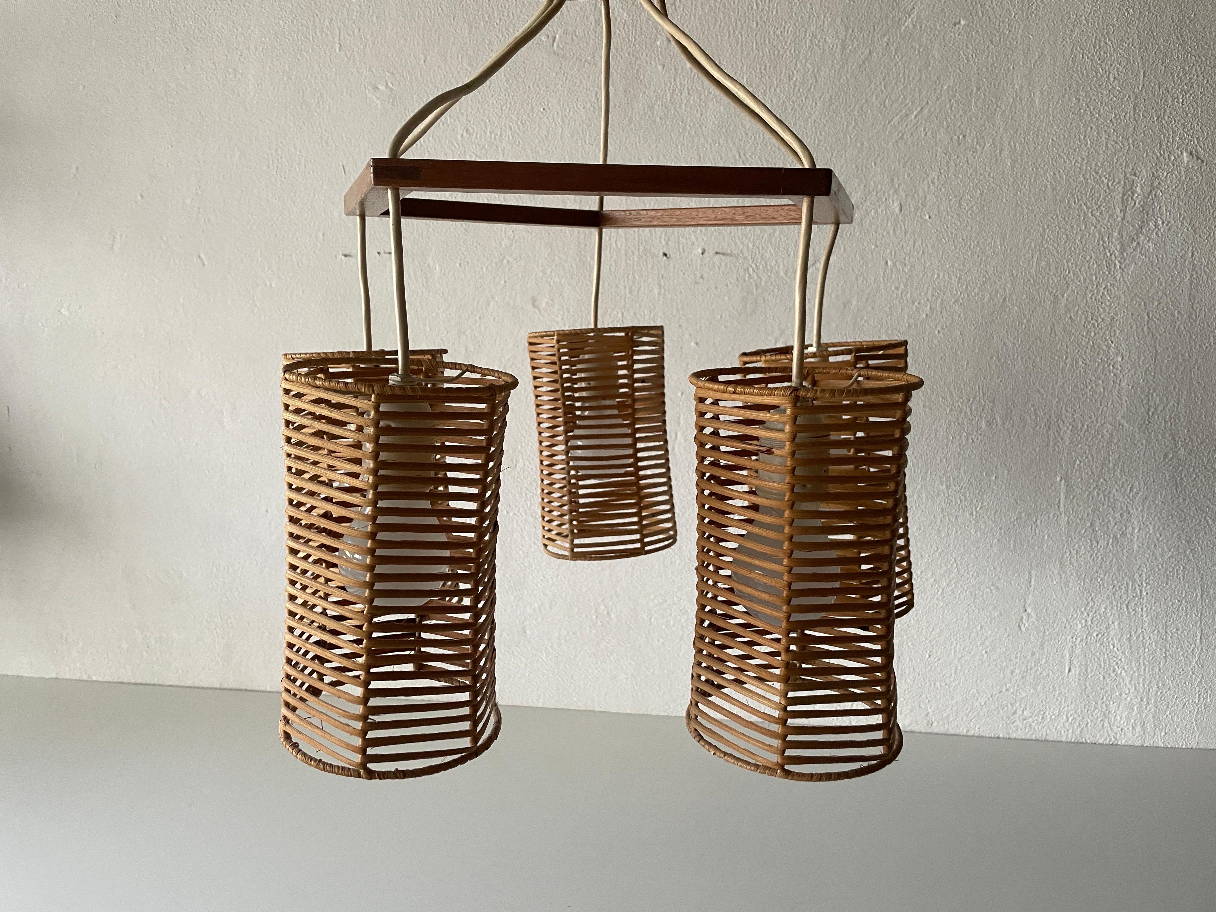 5-head Wicker and Wood Pendant Lamp, 1960s, Germany

Lampshade is in very good vintage condition.
No crack, no missed piece.
Original canopy.

This lamp works with 5x E27 light bulb. Max 100W
Wired and suitable to use with 220V and 110V for all