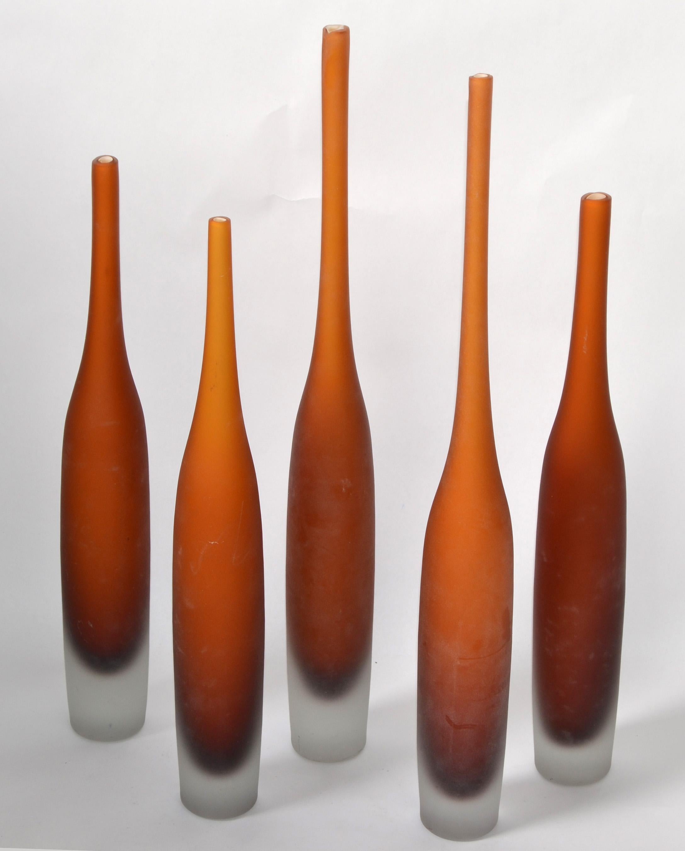 Set of 5 Dark Amber Scavo Glass Murano Art Glass Bud Vases, Bottles, Vessel, Decanter Mid-Century Modern made in Italy in 1980.
The inside is lined with white Glass.
3 Smaller Vase measures: 16 inches Height.
2 Larger Bottles measure: 20 inches