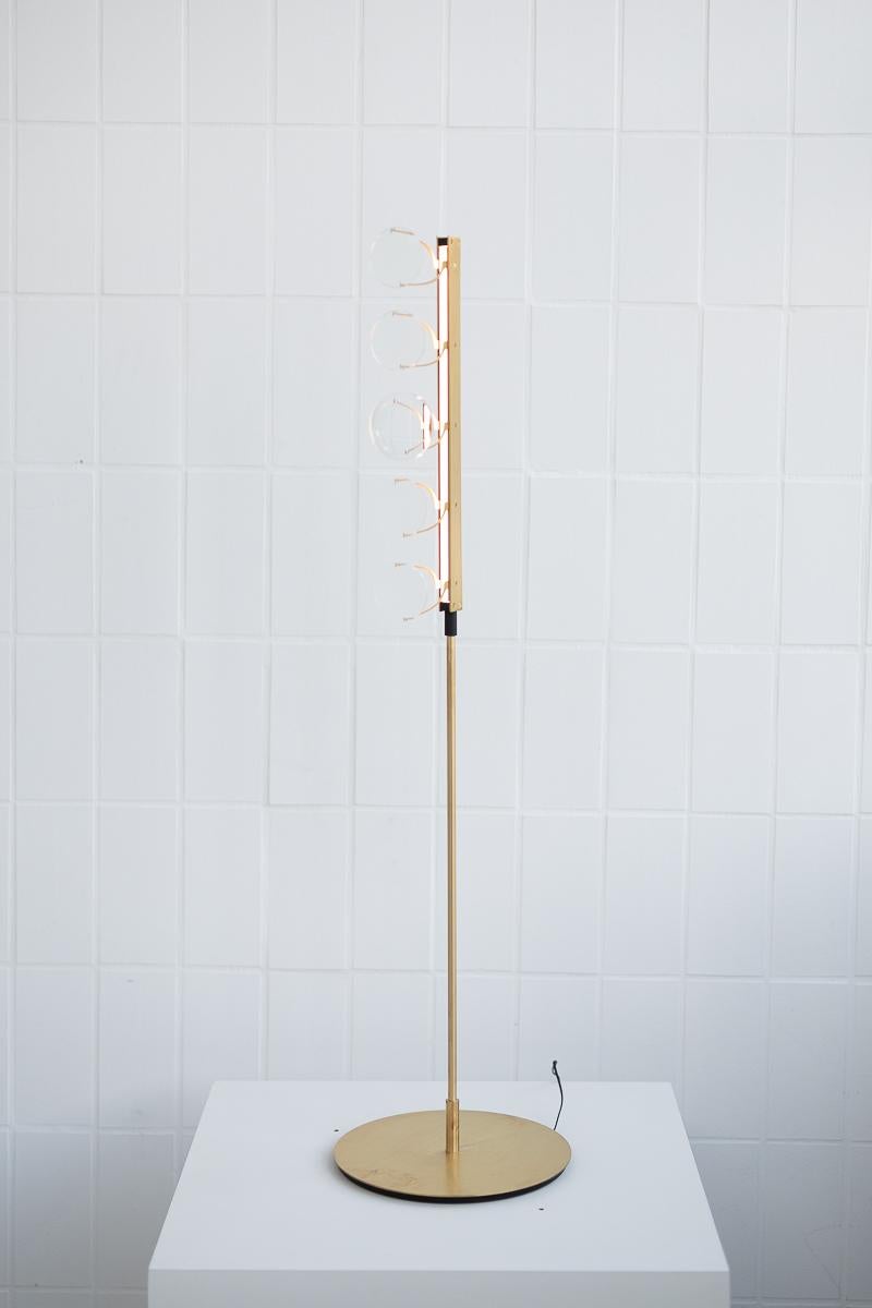 5-lens floor lamp by Object Density
Handmade
Dimensions: Ø28 x 108 cm
Material: Brass (Messing), optical lenses, dimmable 12V LED

Through a close inquiry into an optician’s process and production, Object Density have realised the opportunity