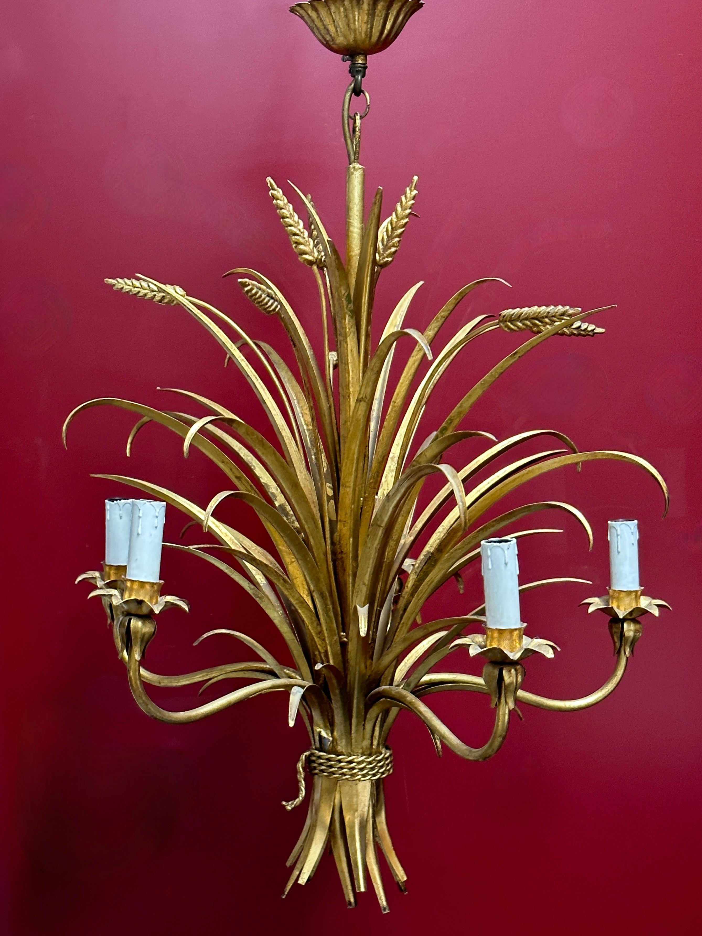 Gilt german Floral sheaf of wheat five-light chandelier Coco Chanel Hollywood Regency style, this chandelier, inspired by Coco Chanel, with sheaves of wheat has five branches with teardrop lamp holders. This tole pendant lamp has a warm antique gold