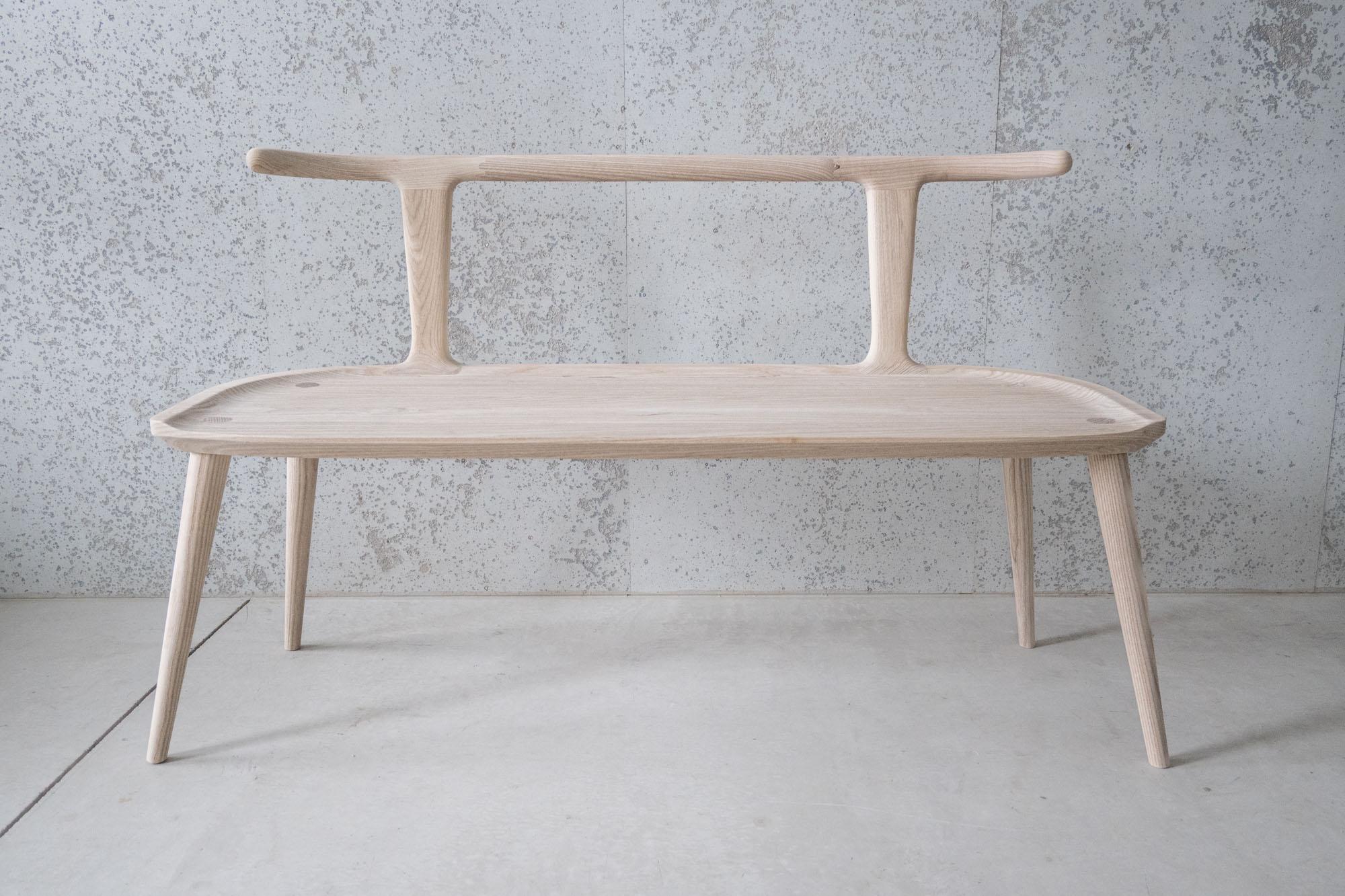 This entryway bench, designed by Justin Nelson for Fernweh Woodworking, evolved out of the Oxbend dining chair, leading also to a matching bar stool. The Oxbend Collection was born from a desire to create seating that is comfortable, organic, and