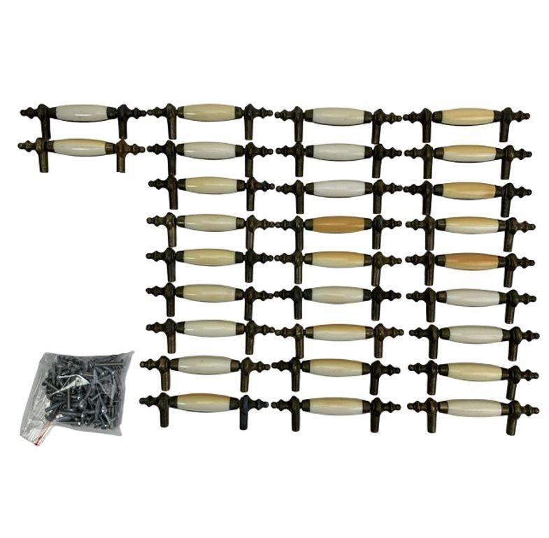 A set of 29 beautiful mid-century drawer pulls featuring dark aged brass with elegant steeple tips and a porcelain white colored Bakelite center. Due to age, some may have a browner coloration. Each handle measures approximately 5