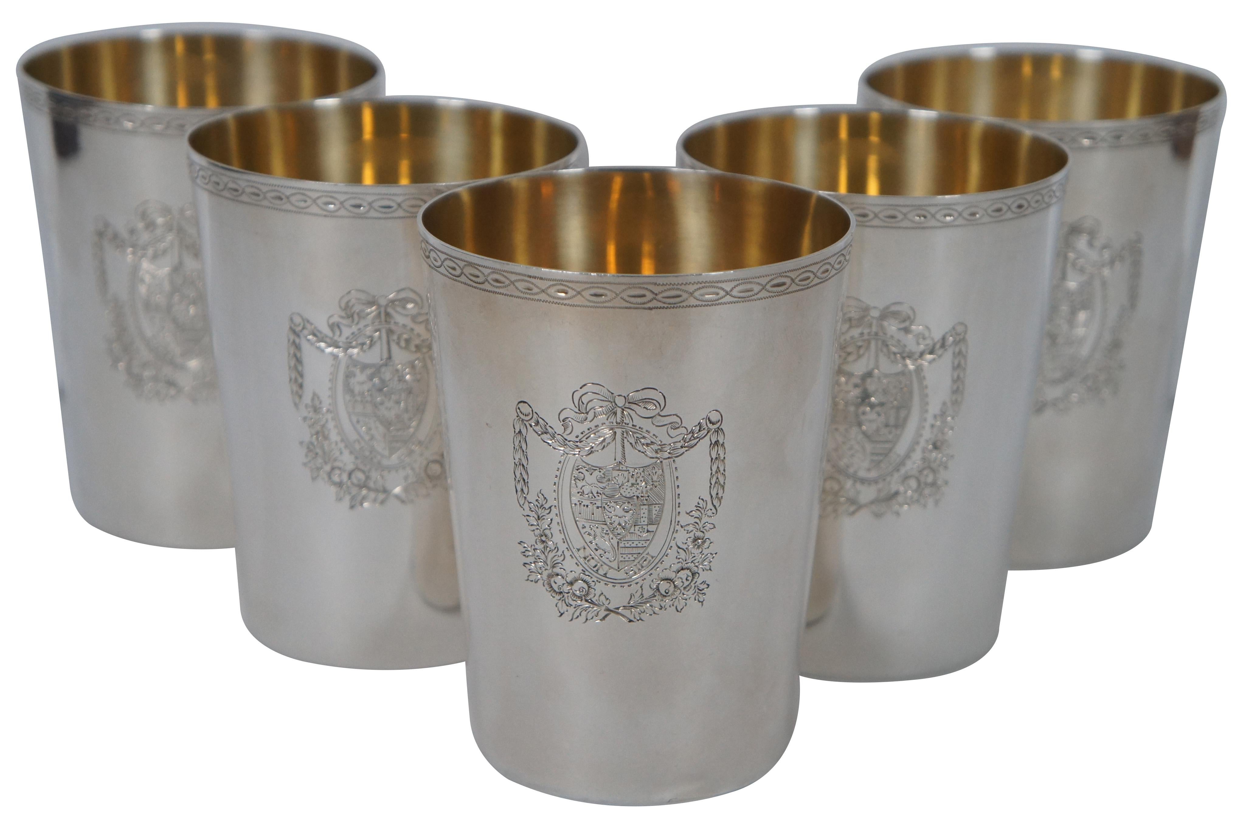 Set of five antique Georgian sterling silver .925 cups / tumblers featuring plated interiors, a decorative band around the top, and stamped with an intricate heraldic coat of arms with the motto “Non Sibi” (Latin: Not for Self). Marked on base with