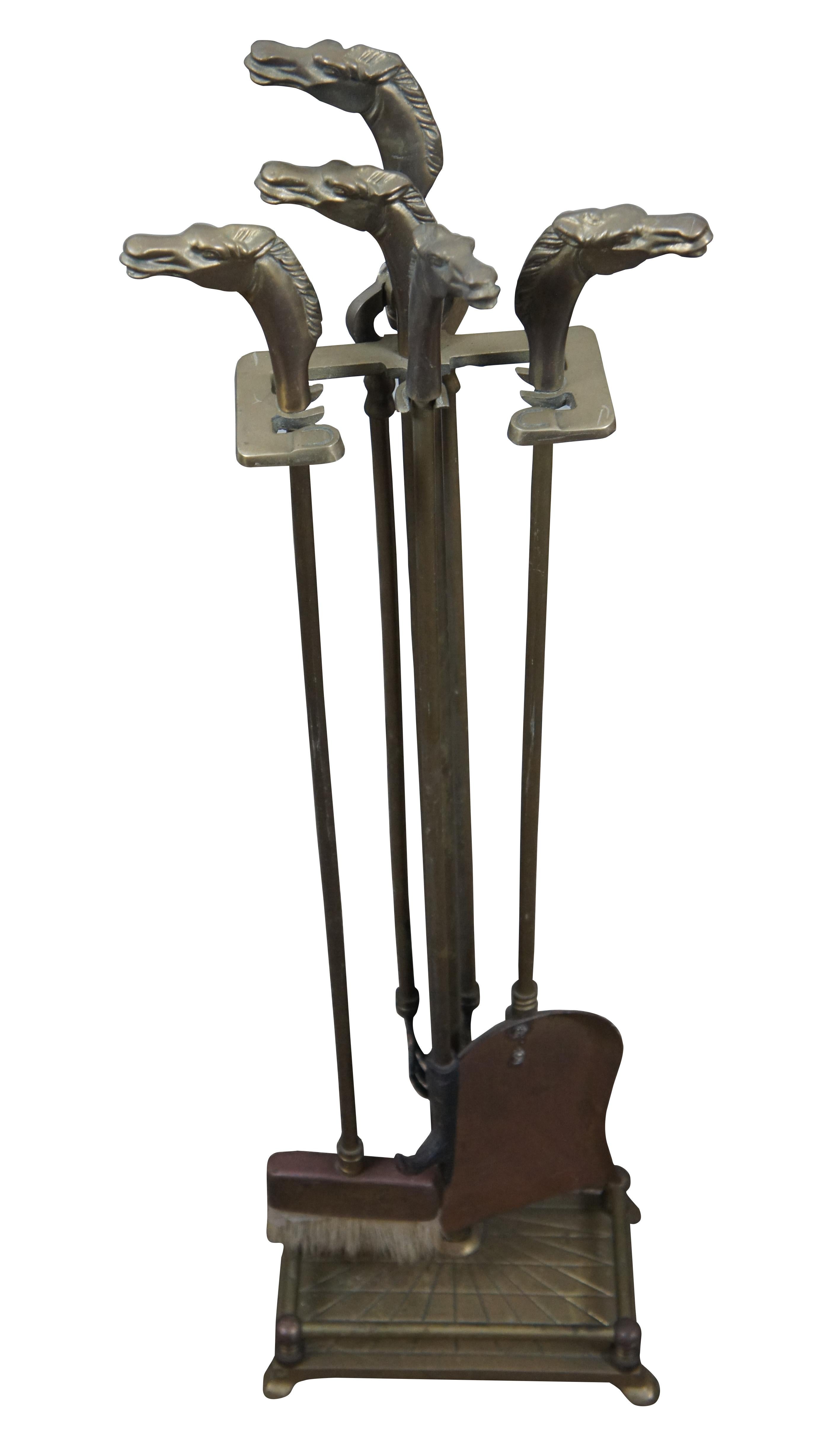 Mid-20th Century five piece set of brass fireplace tools with horse head finials, by Decorative Crafts, Inc. Set includes stand with rectangular base and sunburst detail, tongs, shovel, poker, and brush, all topped with a horse’s head. Base also