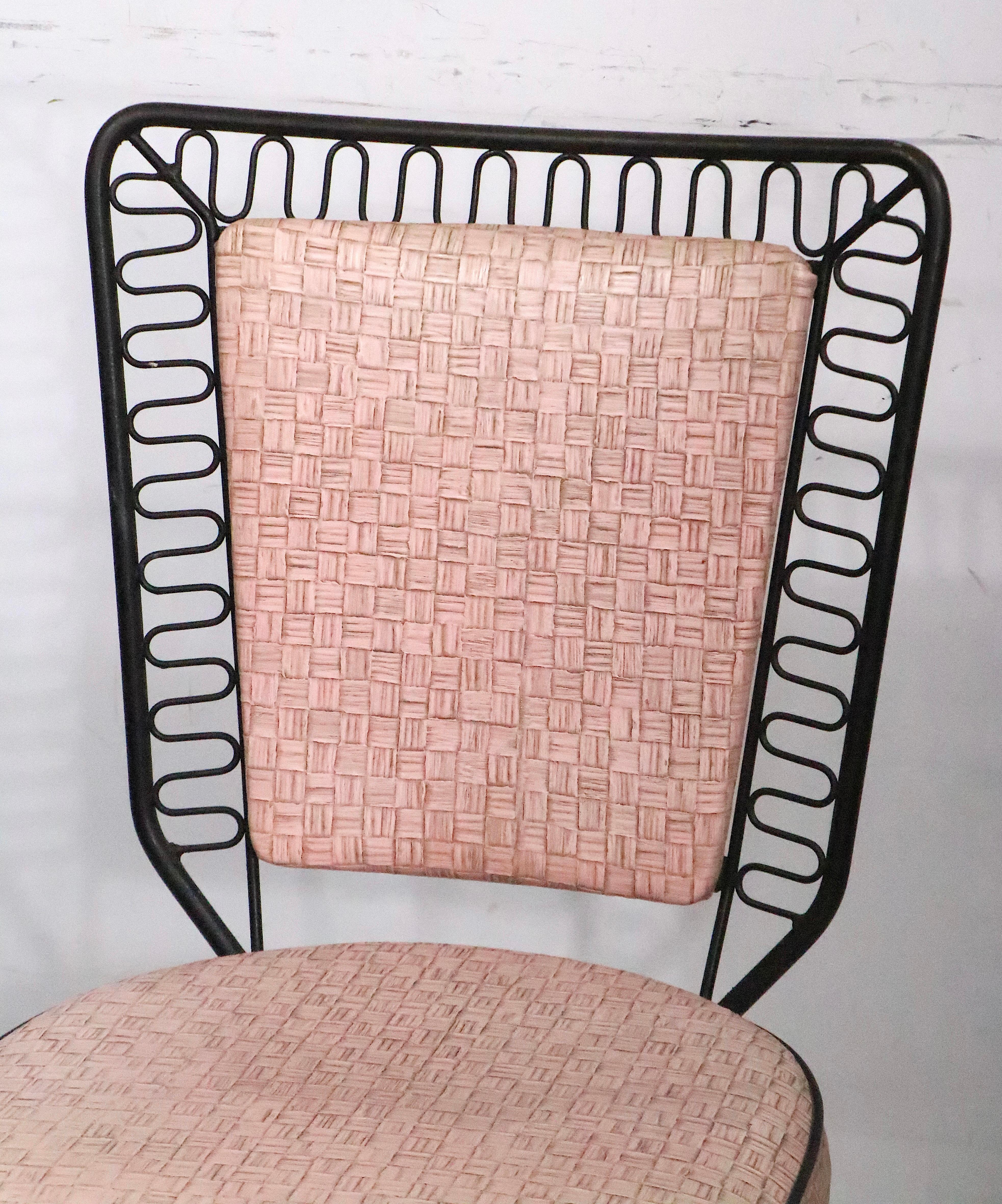 High Style 1950's dinette set marked Finer Chrome Products Co. Bronx 1955. 
 This incredible set features a table with a marbleized black formica top, a squiggle wrought iron table skirt, and tubular black splayed legs, and original 12