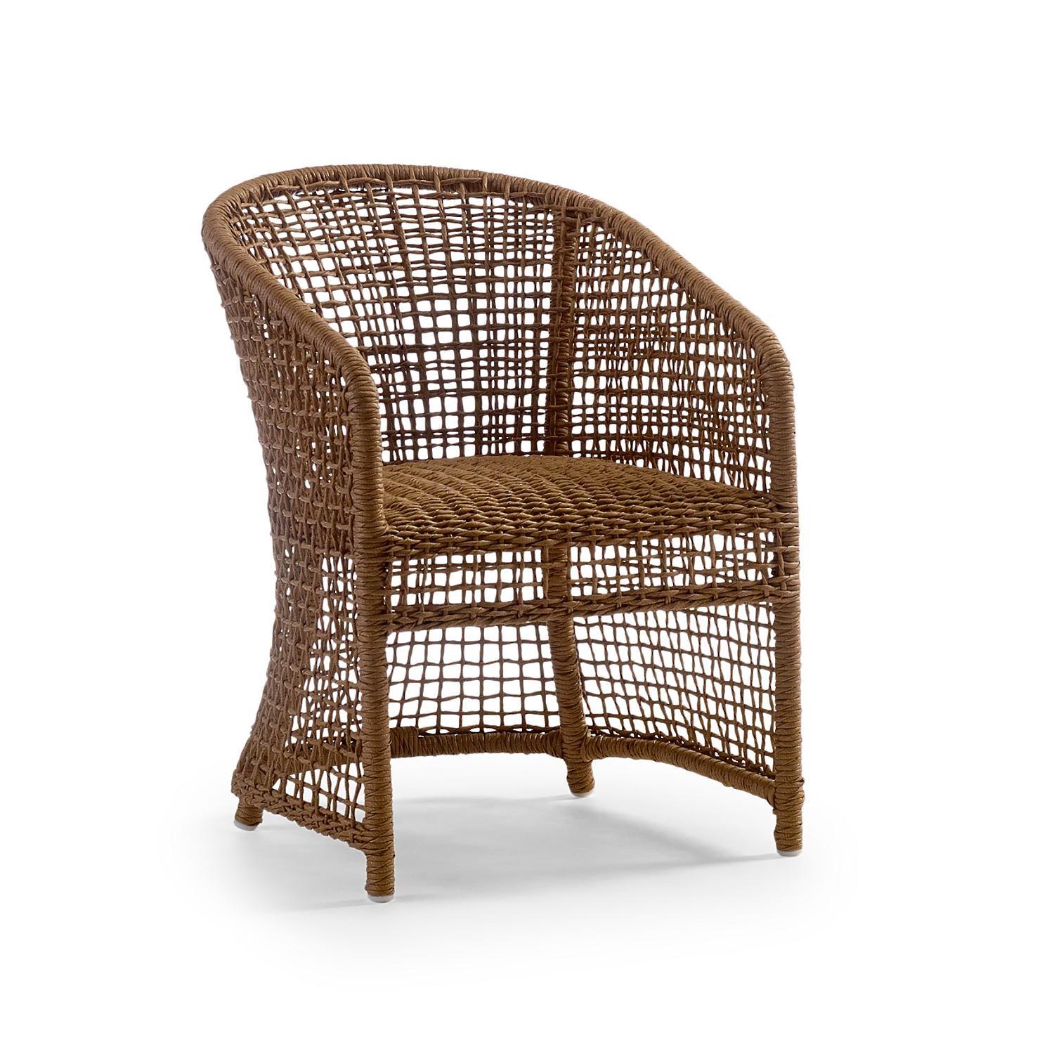 A transitional outdoor dining collection composed of 4 dining chairs and one dining table. Each chair features all-weather woven resin wicker in a natural finish with a powder coated metal frame. Each upholstered component is integrated with