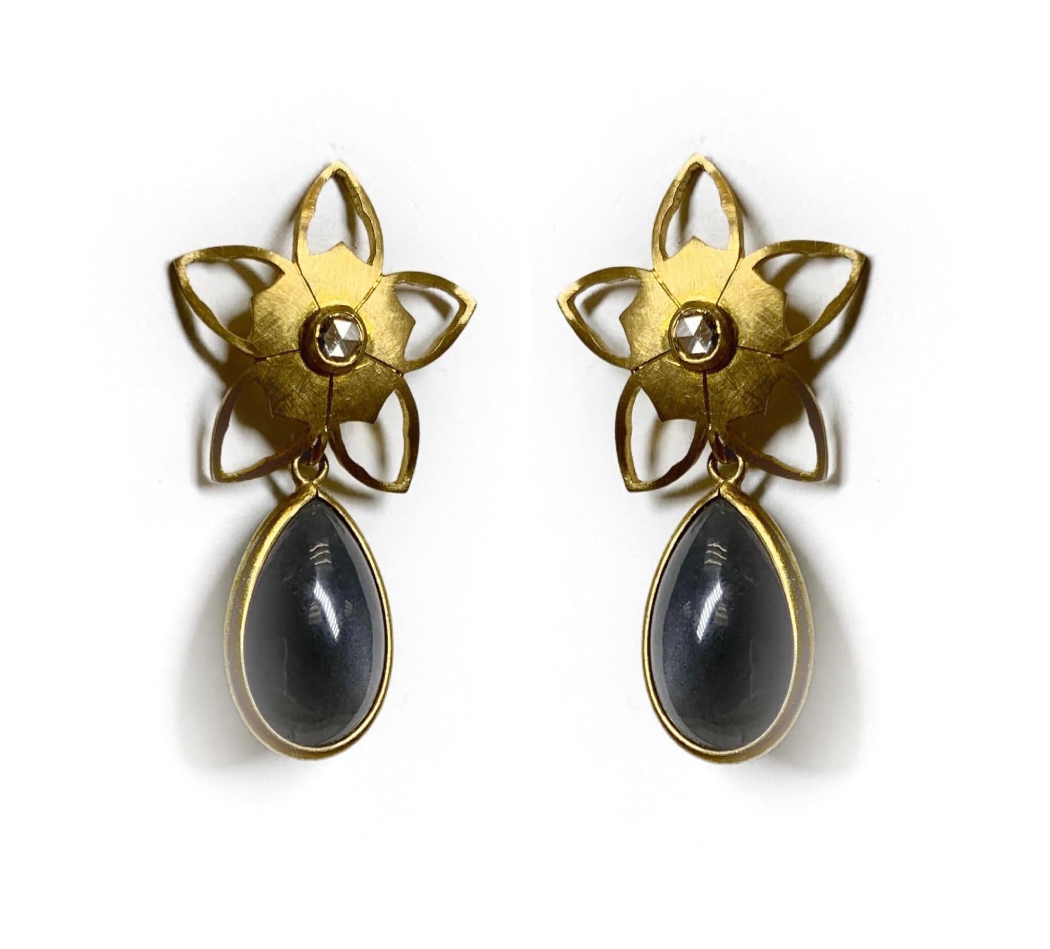 These very unique detachable earrings come with a flower made out of 18 Karat Yellow Gold and diamond center along with two detachable pear shaped Moonstones, either in white or in grey Moonstone. 

Moonstone is known to cultivate compassion and