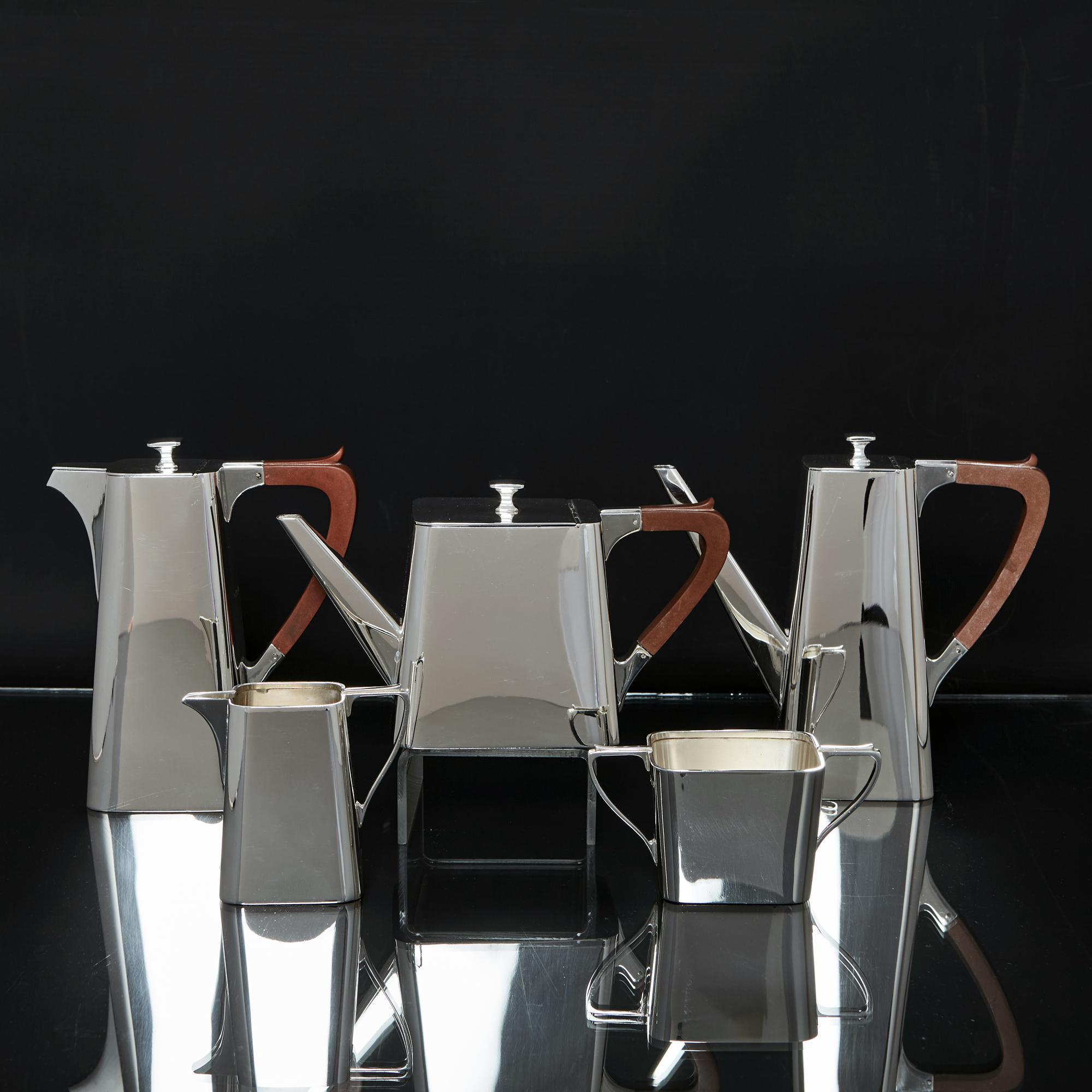 A stylish Art Deco period five-piece silver tea and coffee service comprising teapot, coffee pot, hot water jug, milk or cream jug and sugar bowl. Square with rounded corners, this most unusual design is extremely simple and elegant with subtle Art