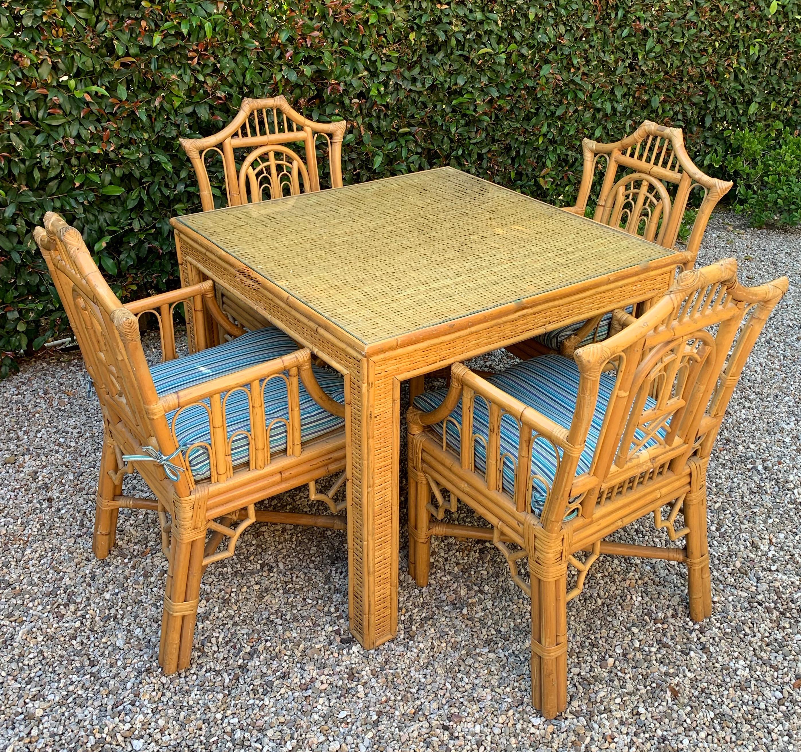 5-piece Chinese Chippendale style bamboo game table or dining table and armchairs with regency influences, an exceptional set of uniquely designed chinoiserie Chippendale chairs in Pagoda style, all with arm and Sunbrella Brand striped cushions,