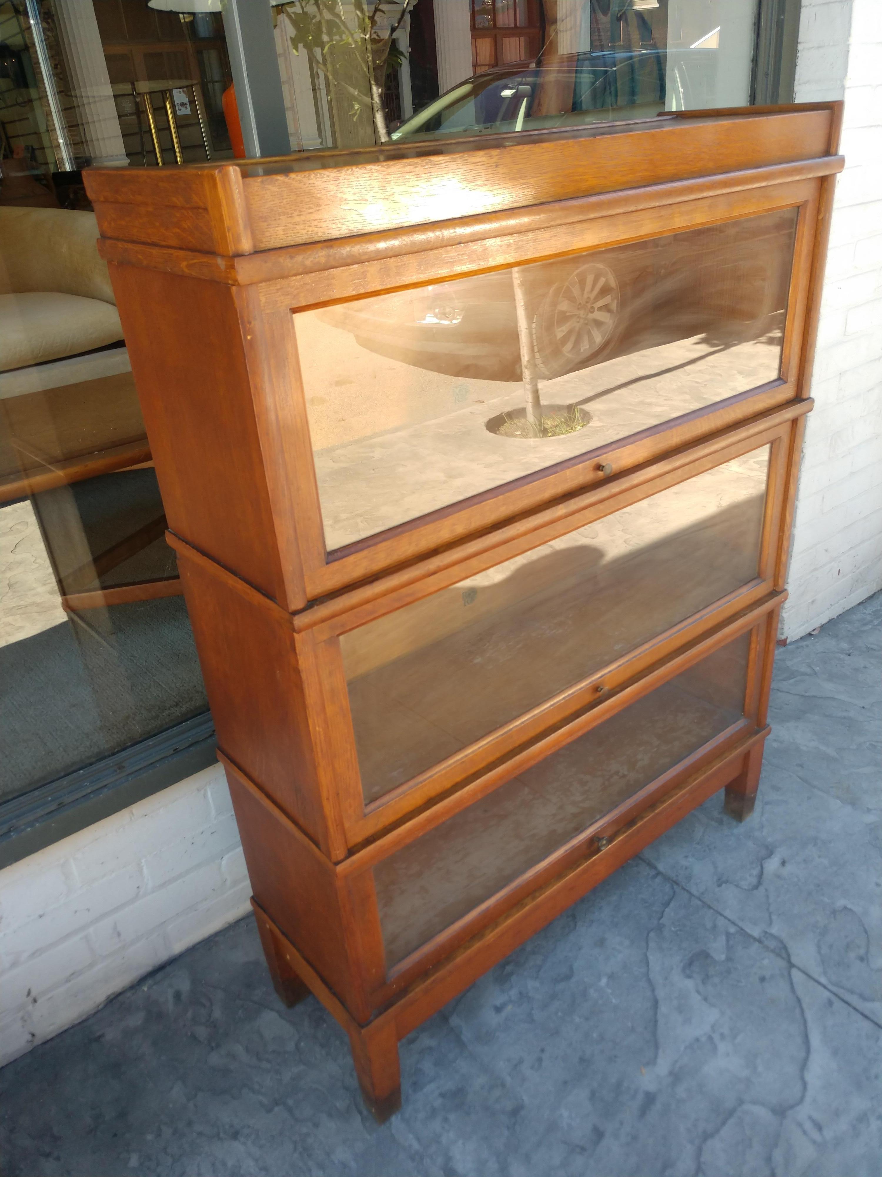 Fabulous 5 pc quarter sawn oak stacking Bookcase. 3 storage sections with a top and bottom. Storage sections sizes are 9.5d x 10.5h x 32, 2 pcs. & 9.5 x 8.75h x 32, 1 pc. In excellent vintage condition with minimal wear and original finish. Doors