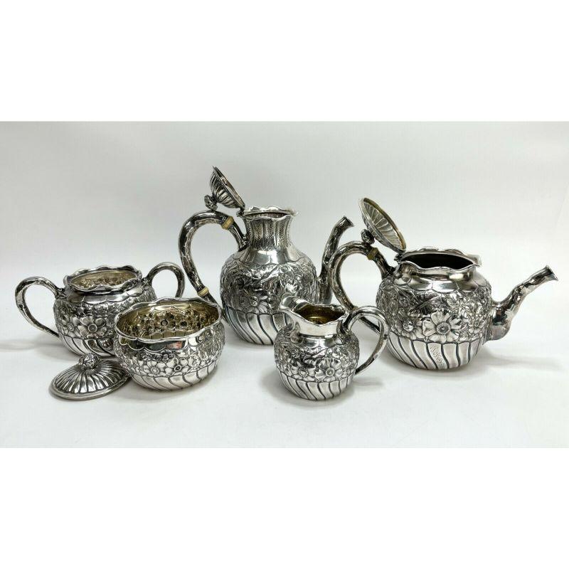 5 Piece of tea & coffee service Gorham sterling silver in Eglantine, 1887

Repousse flowers and swirls with hand hammered handles. Waste bowl and creamer with gilt interiors. A 4 letter indistinguishable monogram to each piece. Gorham sterling