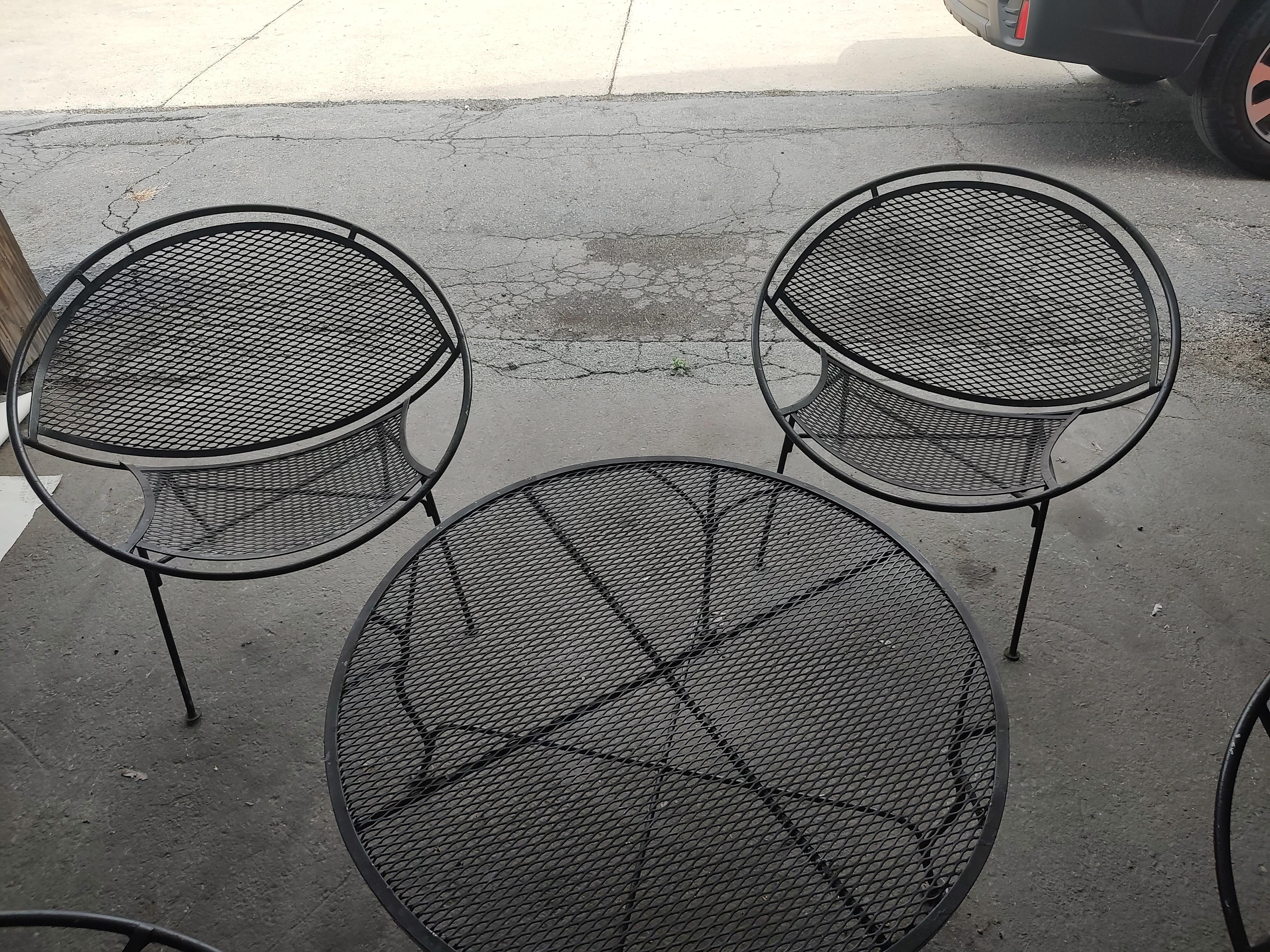 Spectacular 5 pc set which includes 4 Radar Styled lounge chairs and a cocktail table by Maurizio Tempestini for Salterini. In excellent vintage condition with minimal wear, old black paint is in good condition. Sturdy and comfy, this set was in the