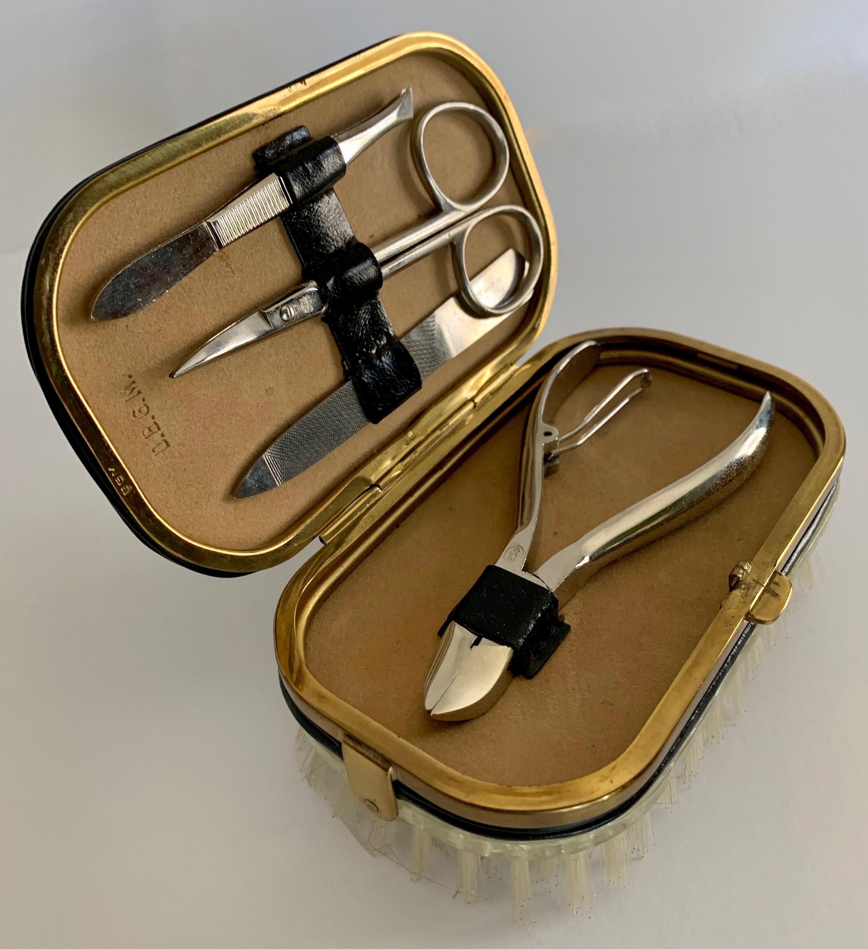 A handsome compliment to the men's dressing table, dressing room or Valet. The attractive Garment brush, with brass trim, and clasp opens to reveal a file, nail cutter, cuticle scissors & tweezers. Additionally, the brush is removable and a small