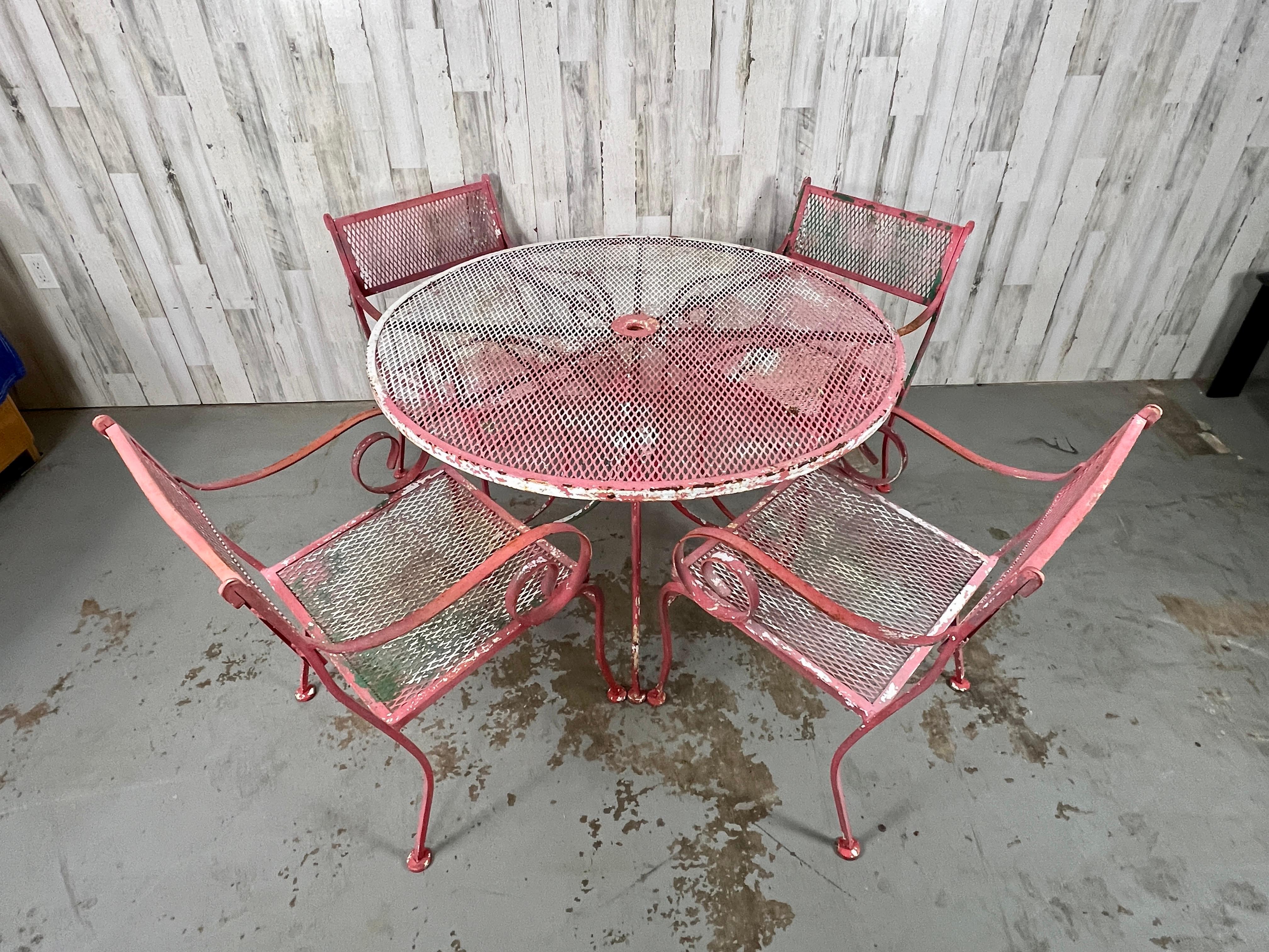 One table and 4 dining chairs make this garden set a real eye catcher with its many coats of multi-colored paint. This set is in very sturdy condition and can be used as is or re-powder coated for a additional fee.
Table measures, 41.7/8s by 28.1/8