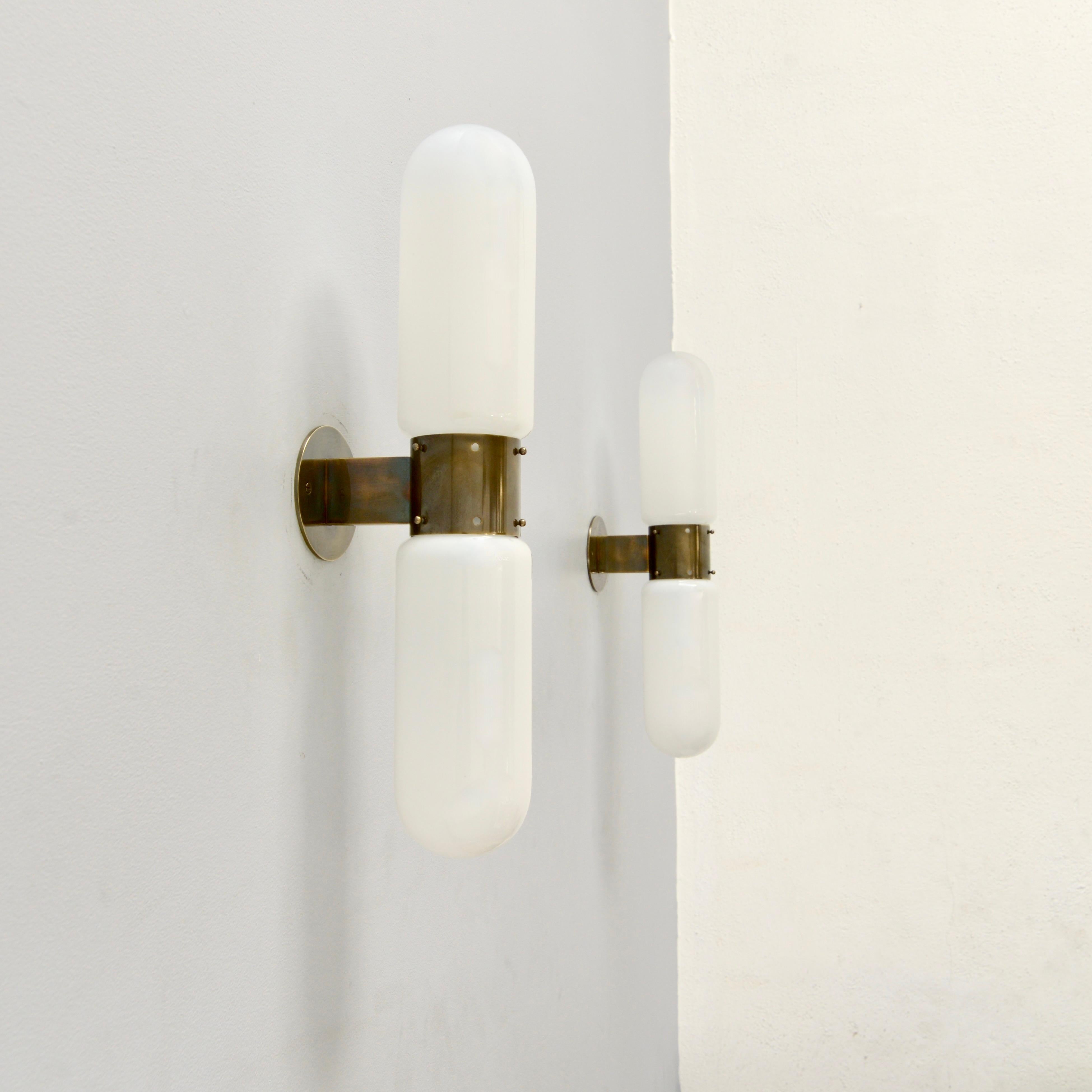 One pair of Italian “Pill” sconces by Carlo Nason for Mazzega . These fully restored sconces are in the original brass and blown glass. Their origins are circa 1960s. Wired with two E-26 medium based sockets per sconce. These fixtures can be wired