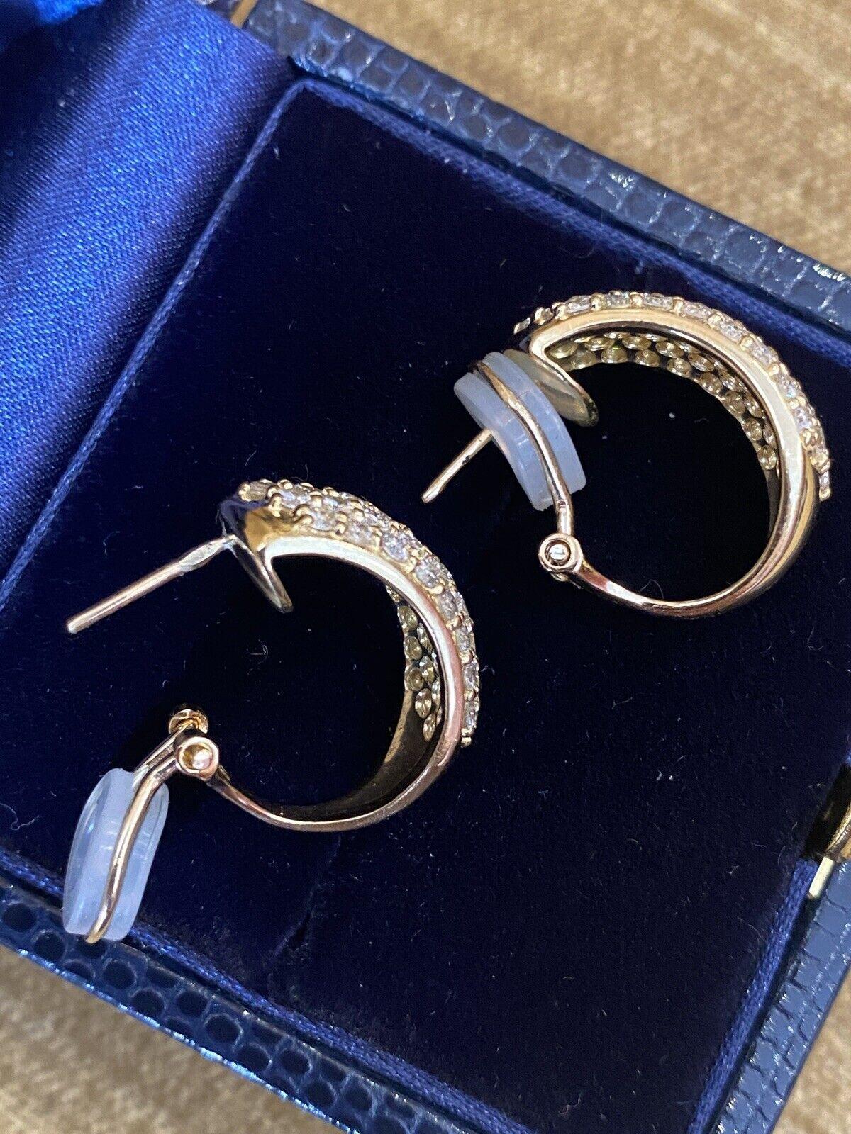 5 Row Pave Diamond Half Hoop Earrings 2.74 carat total weight in 18k Yellow Gold

Diamond Pave Hoop Earrings feature Five Rows of Round Brilliant Diamonds weighing 2.74 carats in total, all set in 18k Yellow Gold. The earrings are secured by posts