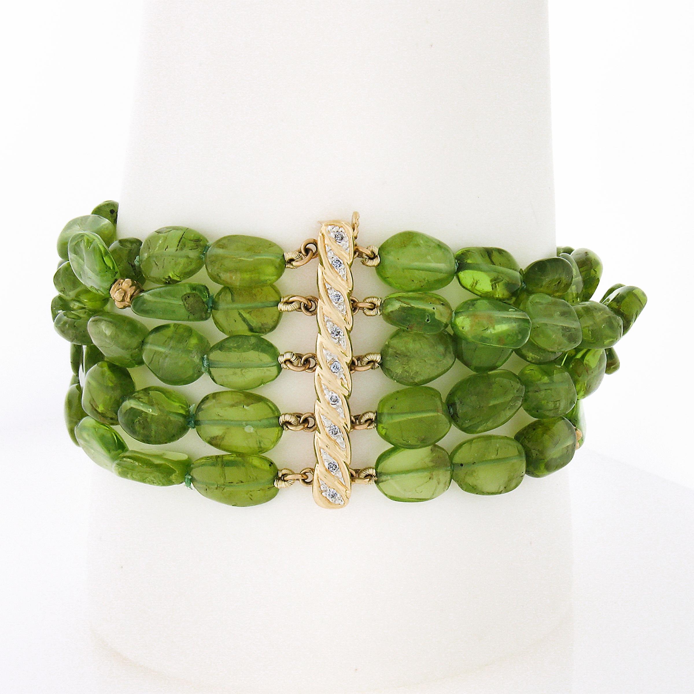 This absolutely beautiful bracelet features 5 strands of tumbled bean shape peridot with bead spacers and push clasp that are crafted from solid 14k yellow gold. The peridots showing a happy and bright lime green color and have a truly wonderful 