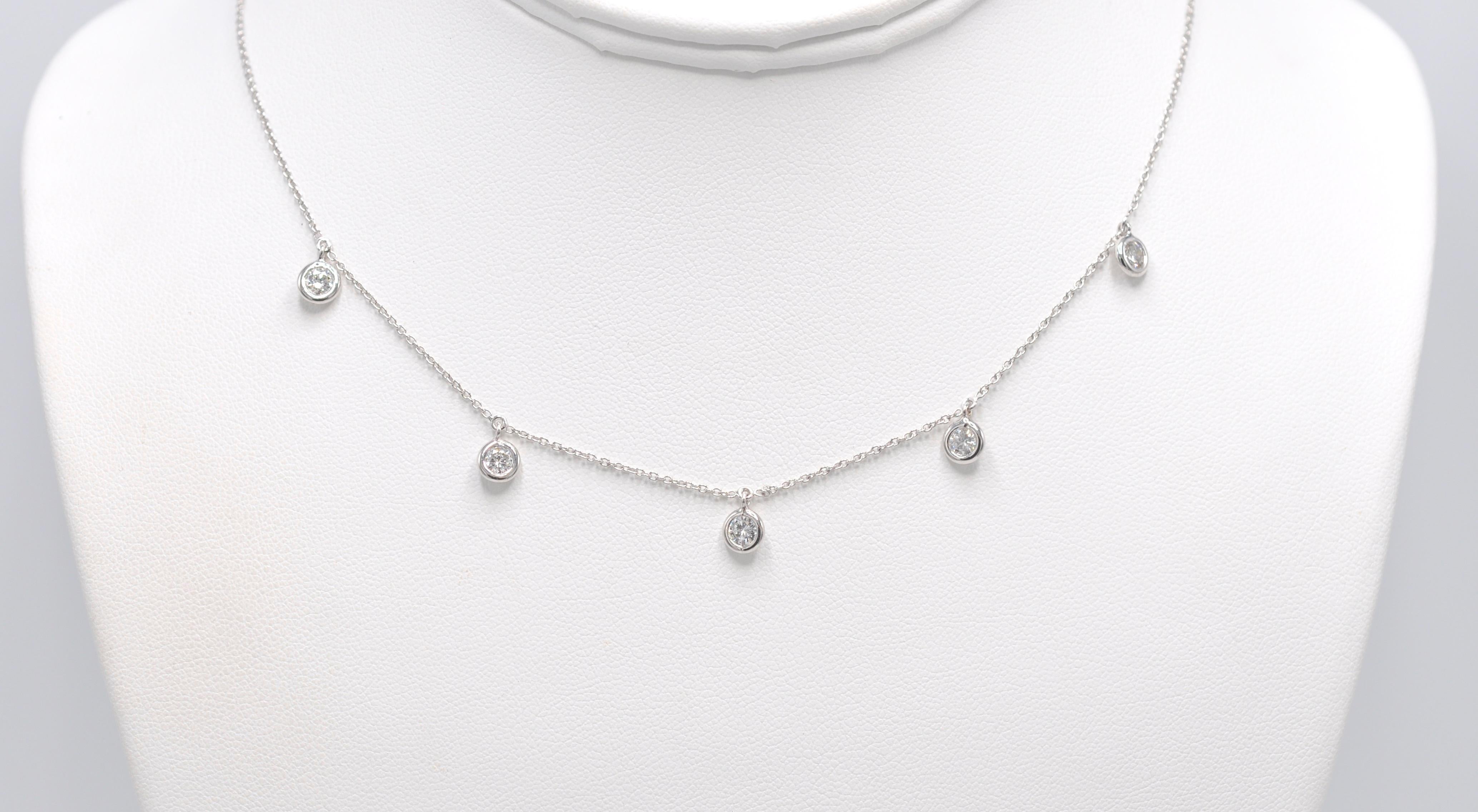 18KW Five Station Bezel Set Diamond Drop Necklace featuring 1.02ctw round diamonds. This is a completely new take on a Diamonds by the Yard- style necklace. This necklace looks wonderful either with a classic white shirt and jeans or a little black