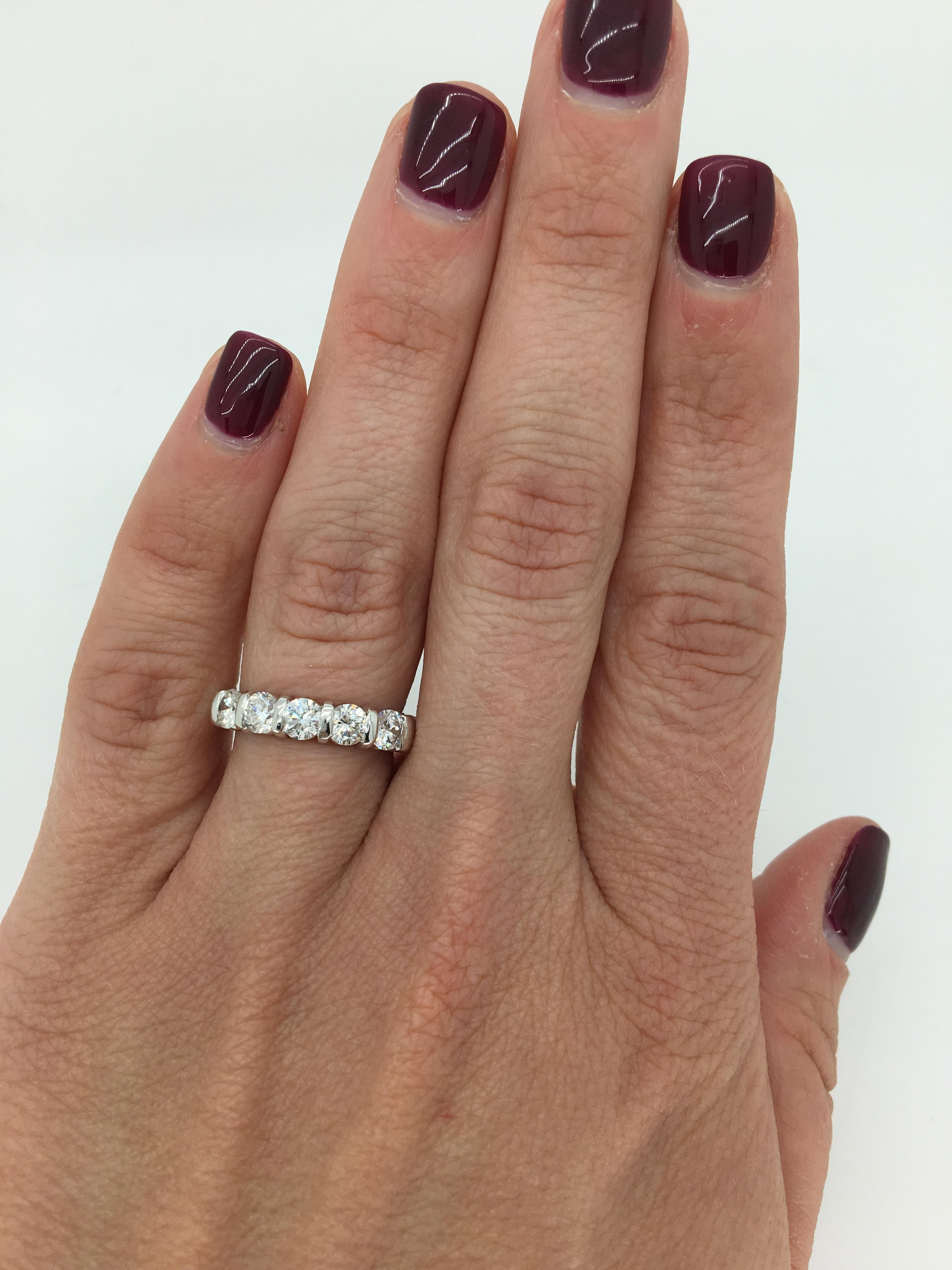 Classic 5-stone bar set diamond band crafted in 14k white gold.

Diamond Carat Weight: Approximately 1.04CTW
Diamond Cut: Round Brilliant Cut Diamonds
Color: Average G-I
Clarity: Average VS2-SI2
Metal: 14K White Gold 
Marked/Tested: Tested 14K Gold,
