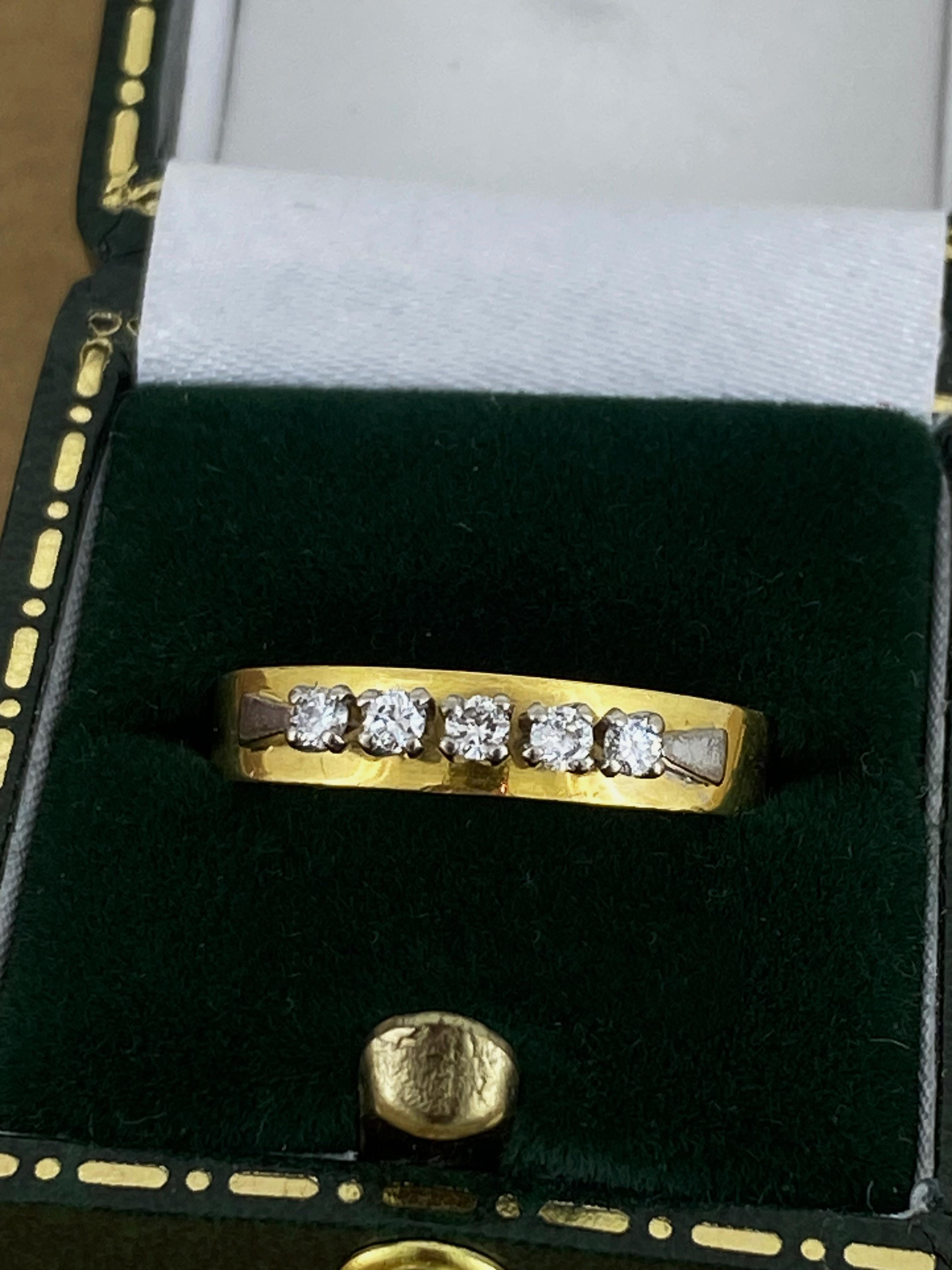 Securely claw-set with
5 Natural Round Brilliant Cut Diamonds 
exhibiting sun-like brilliance, 
of G-H colour, VS clarity, 
totalling 0.25ct approx. 
the setting rises above the finger by 4mm 

The band is crafted in 18K Yellow Gold, 
thick & solid