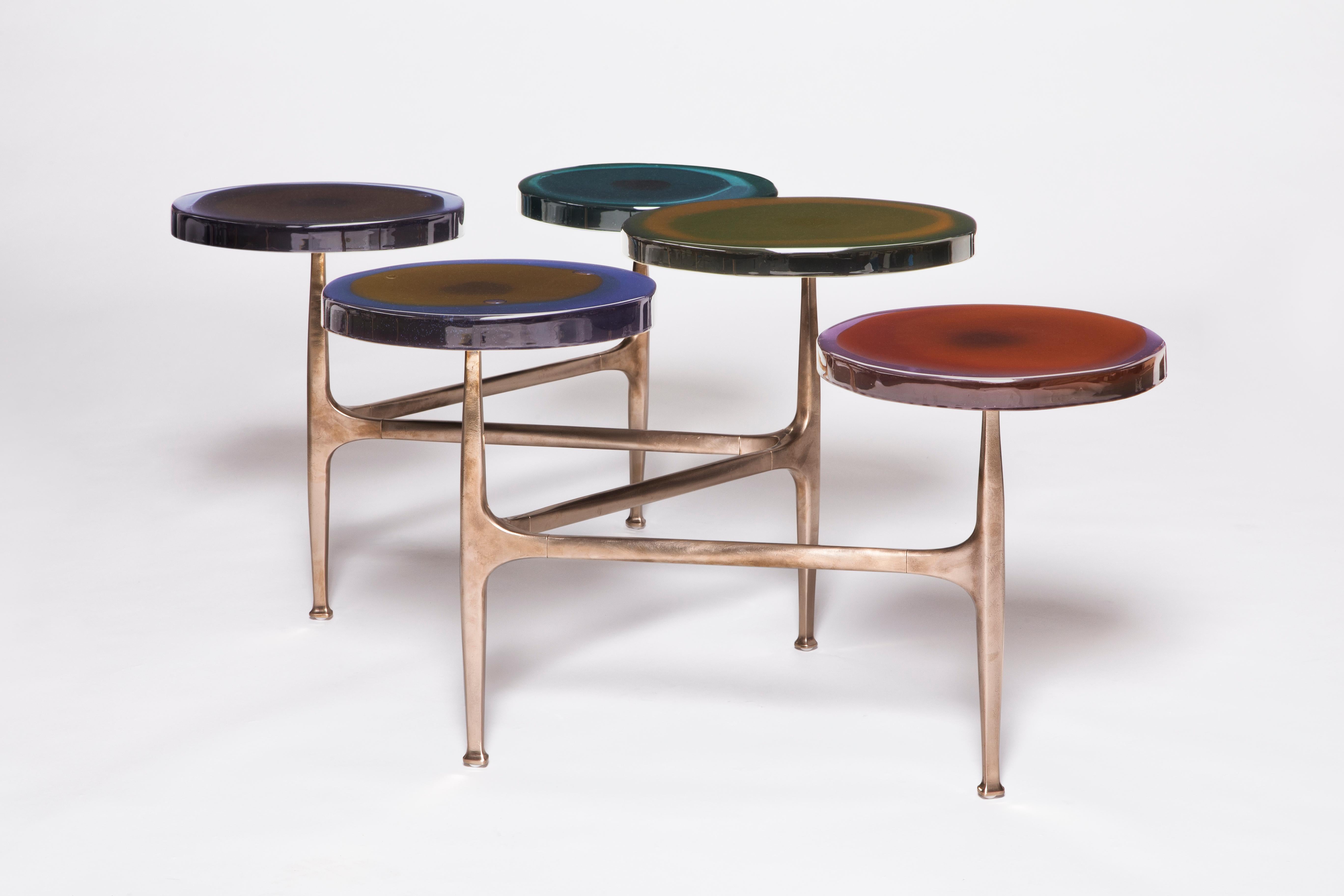 Agatha coffee table by Draga & Aurel
Dimensions: W 121 x D 80 x H 50 cm
 top Ø 32/40 cm
Materials: Resin, Bronze

The Agatha coffee tables are featured by irregular circular tops of transparent and
colorful resin sit on a bronze frame with a